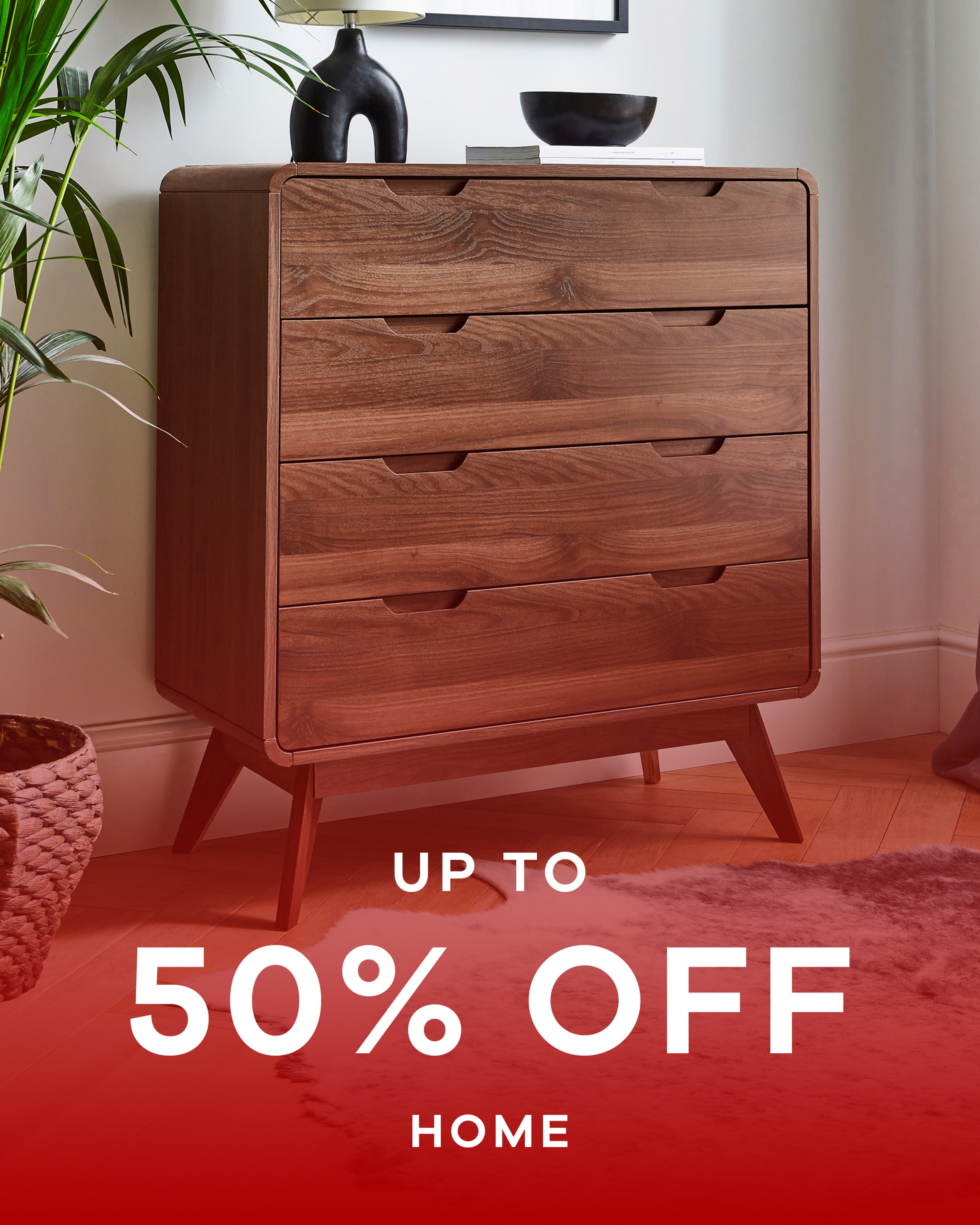 Walnut coloured 4 drawer chest stood against a wall. Up to 50% off home.