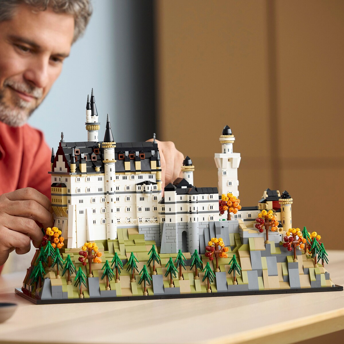 A person building the LEGO Architecture Neuschwanstein Castle