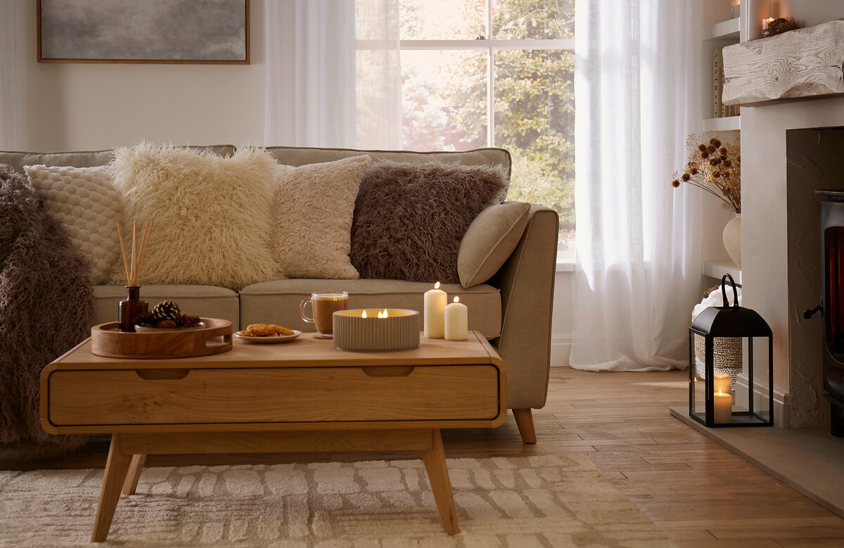 Cozy room with sofa, cushions and lamps
