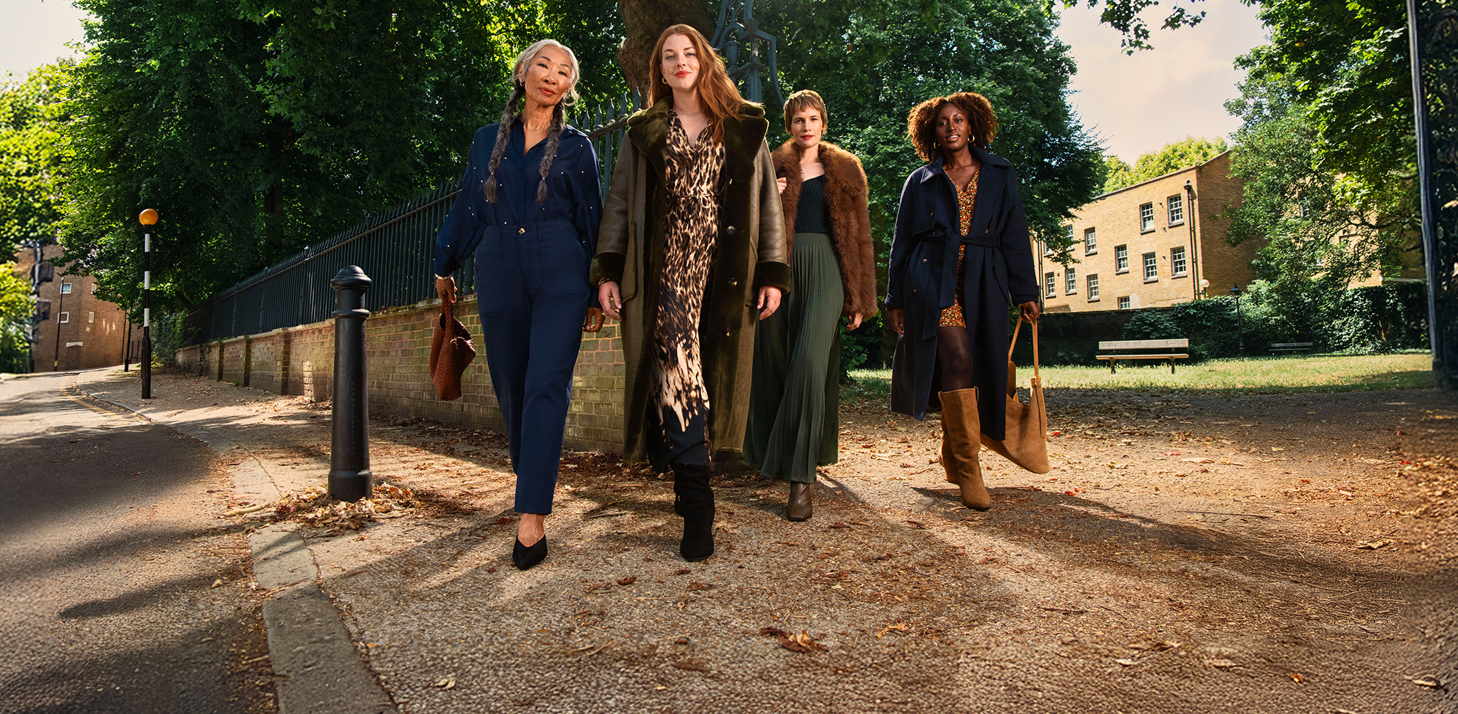 4 ladies walking forwards wearing winter layered clothing