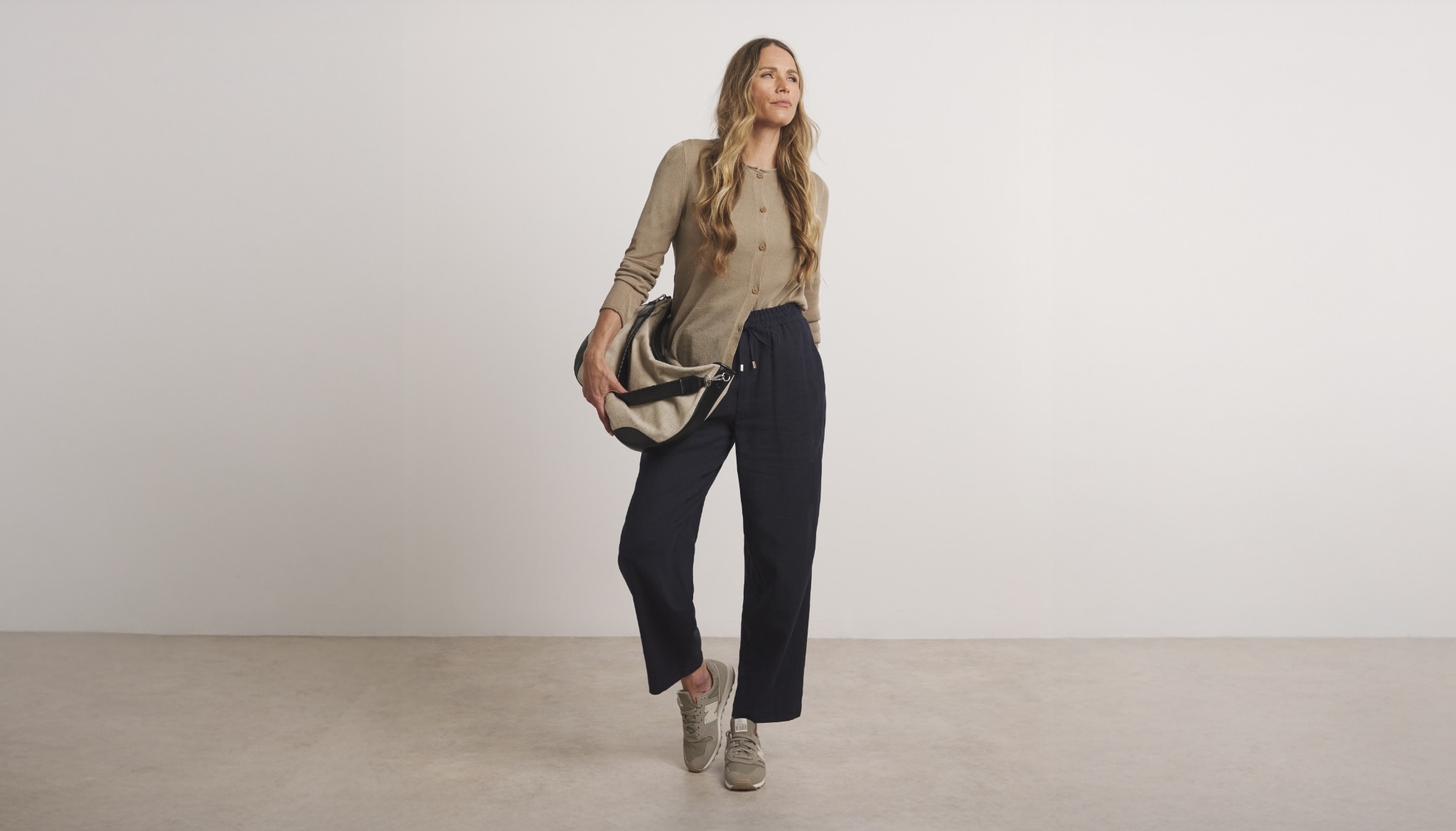 Woman wearing knitted cardigan and trousers