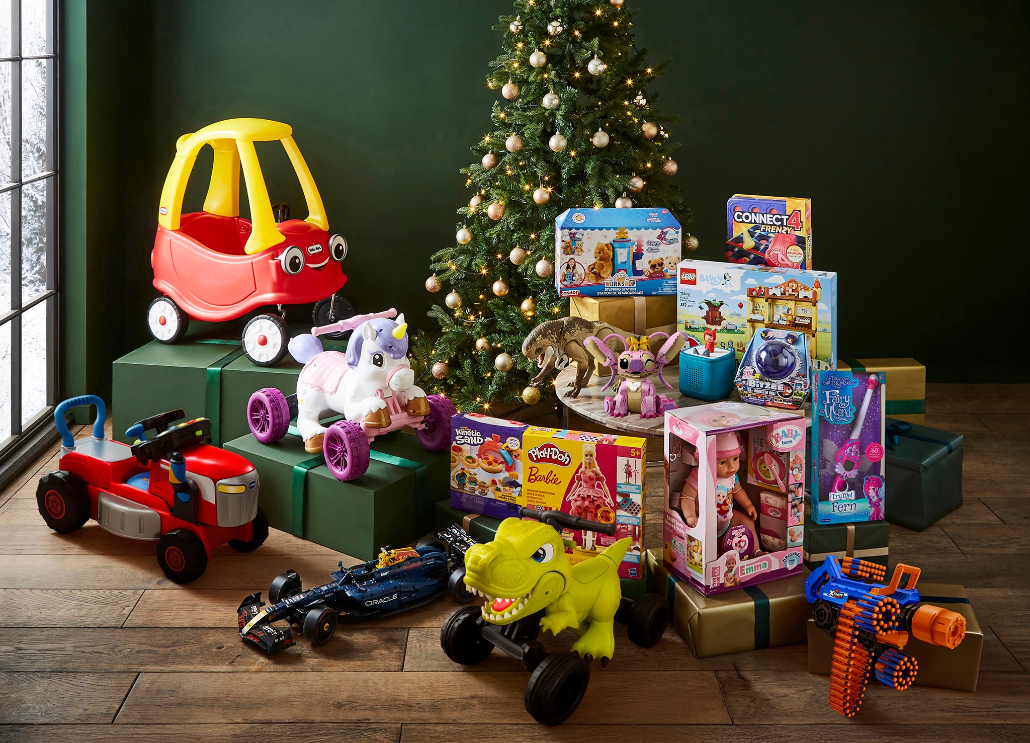An selection of must have toys next to a Christmas tree