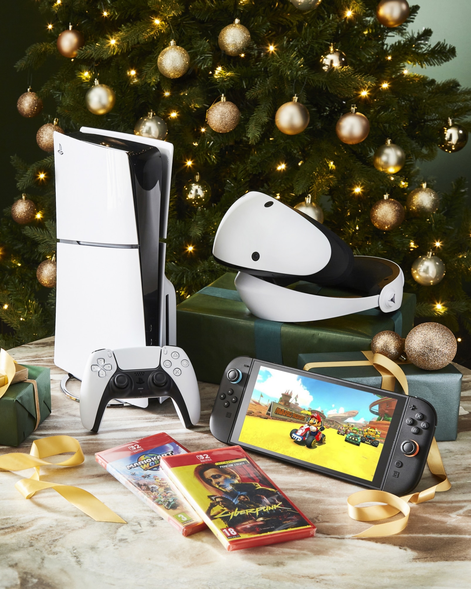 Holiday Gaming Setup With Console, VR Headset, Nintendo Switch, And Christmas Tree Decorations