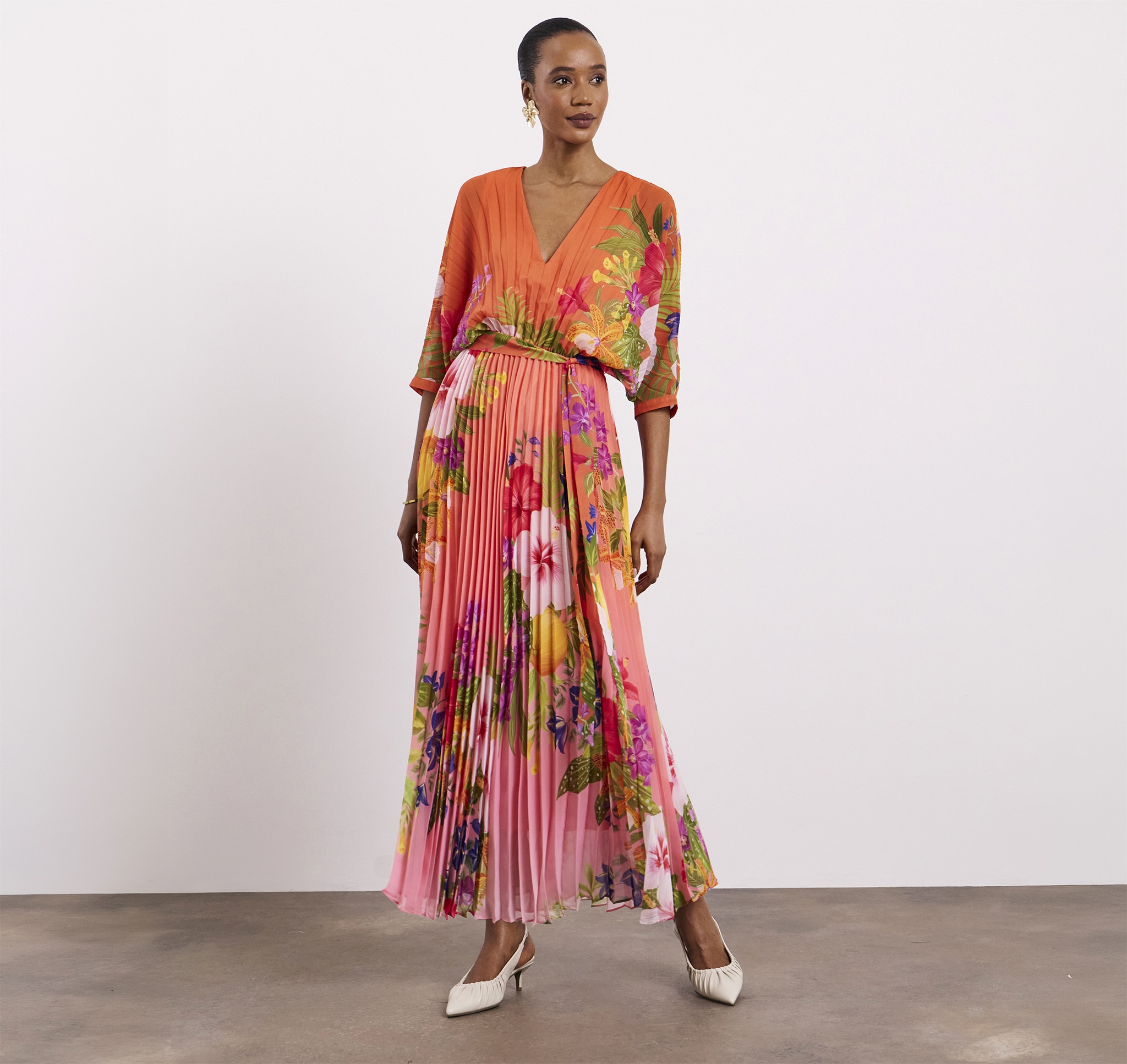 A lady wearing a Joanna Hope printed pleat maxi dress
