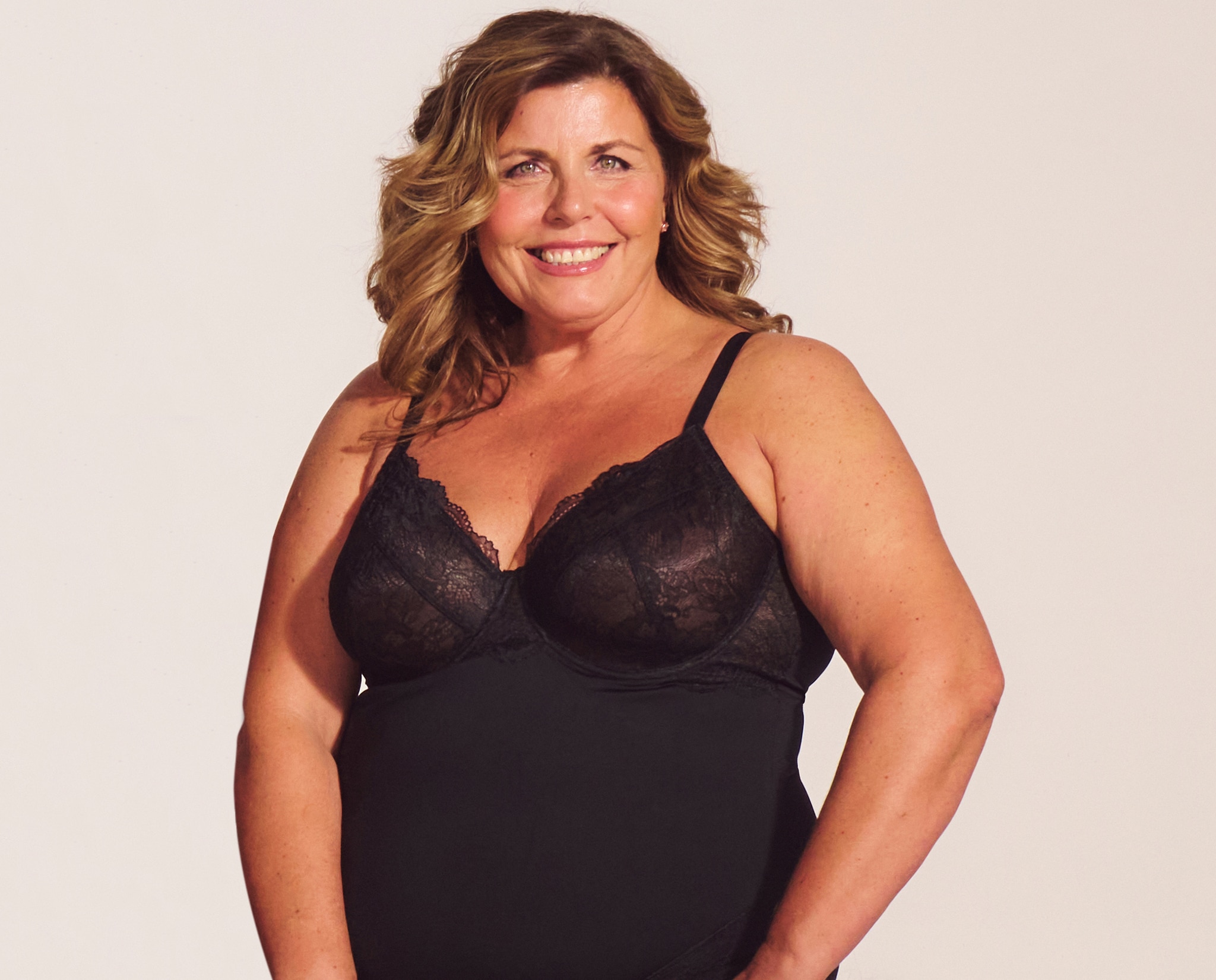 A head and shoulders image of a lady wearing black lingerie