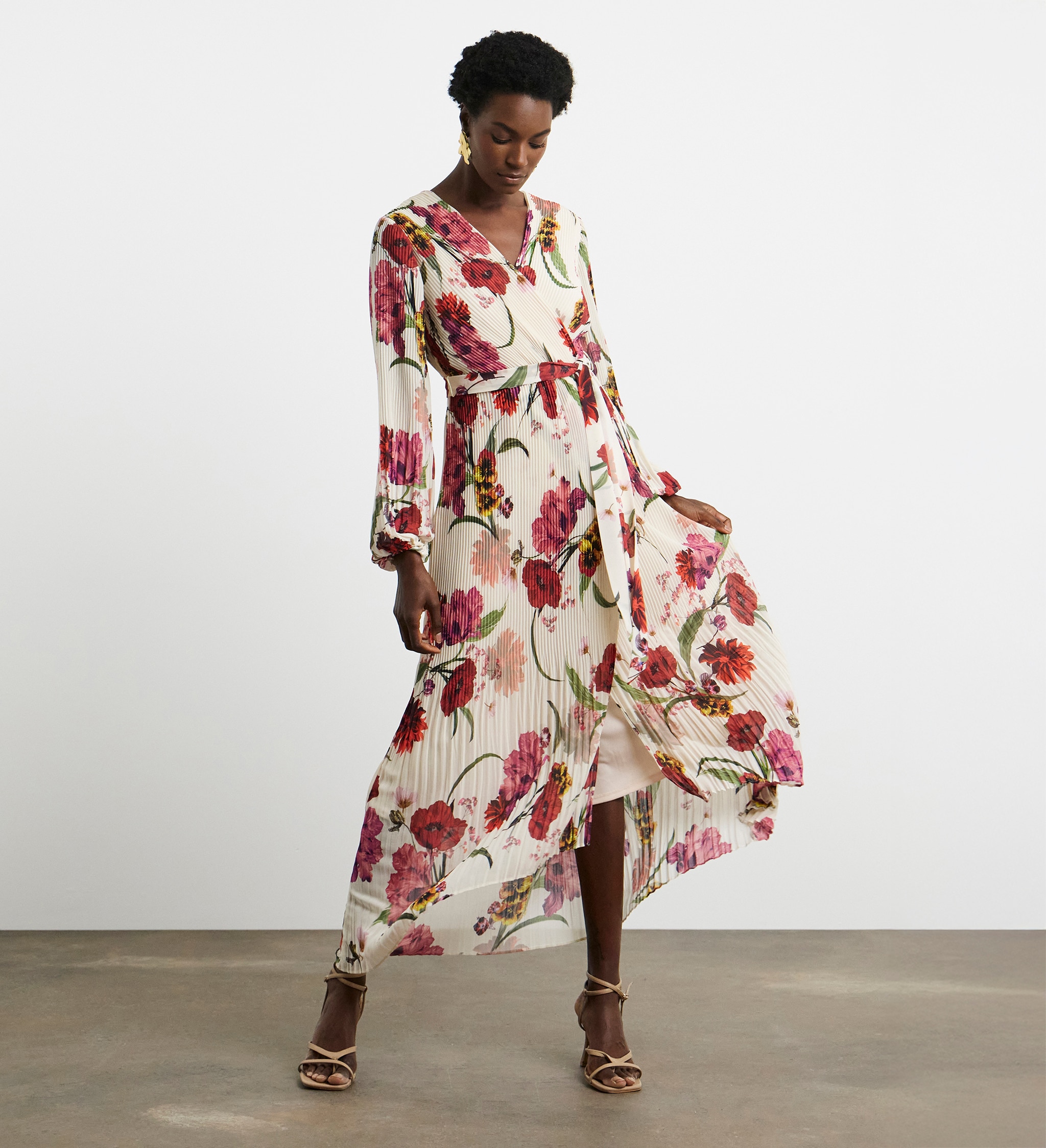 A lady wearing a floral printed long sleeved wrap dress.