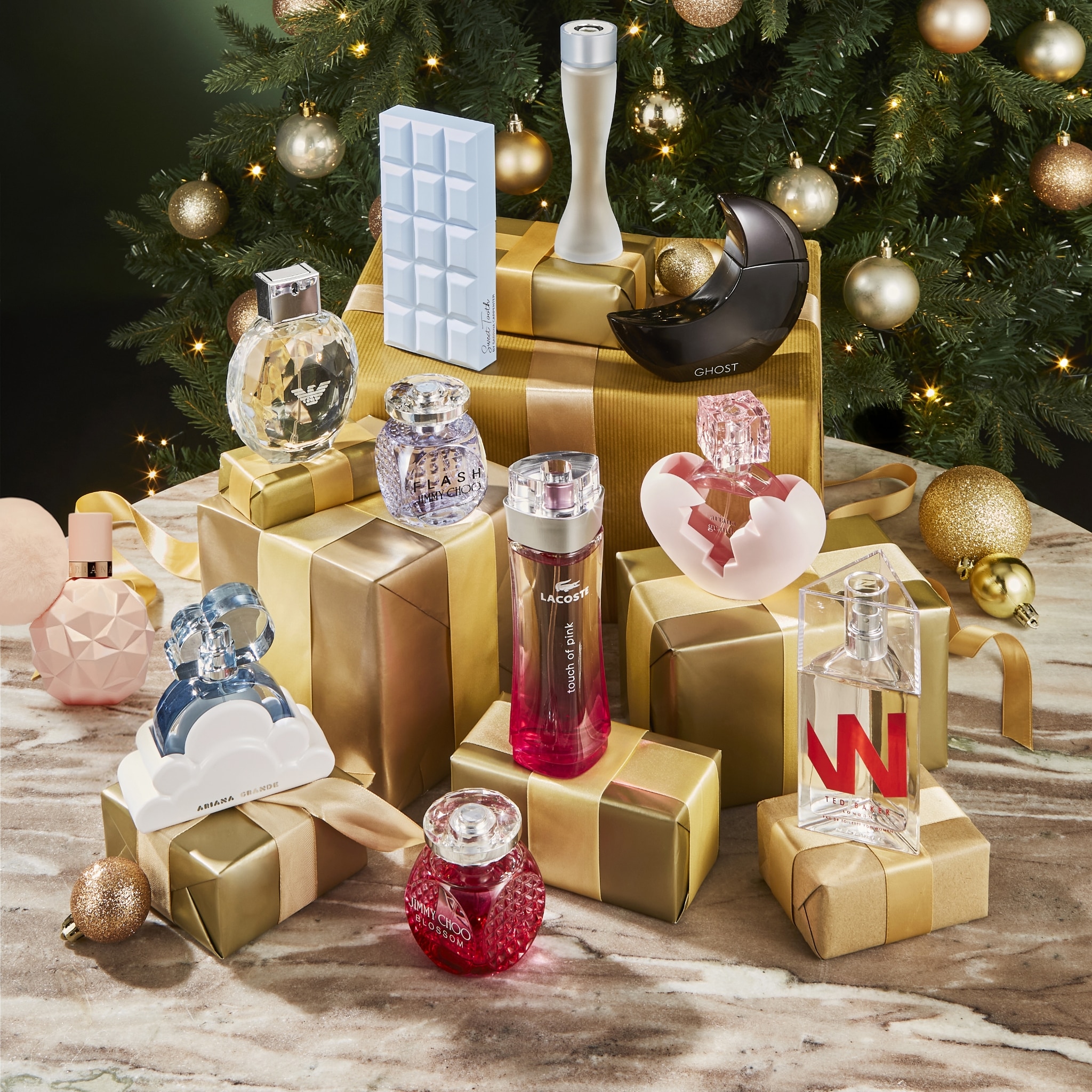 Festive Luxury Perfume Gift Set Under Christmas Tree With Gift Boxes and Sparkling Ornaments