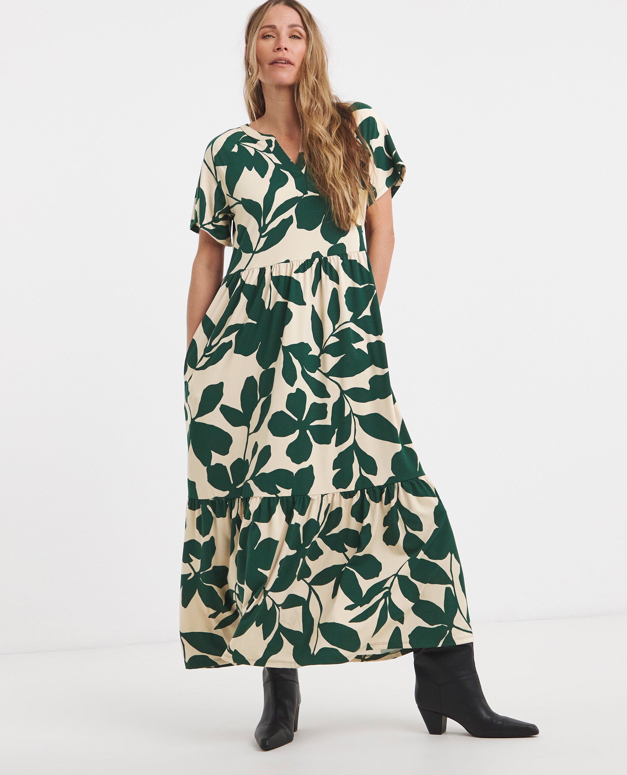 Model is wearing a soft touch notch neck abstract print maxi dress