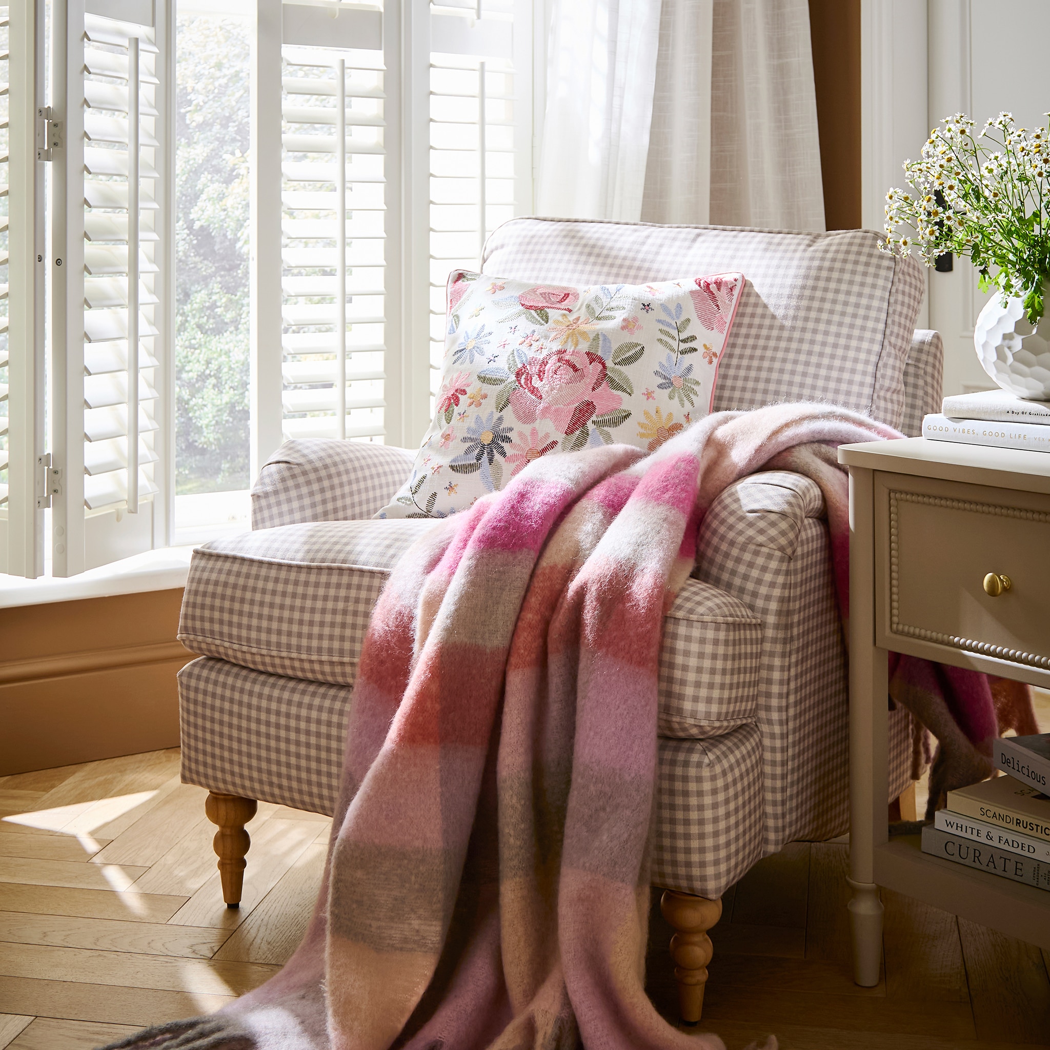 A living room featuring a Wisteria gingham armchair.
