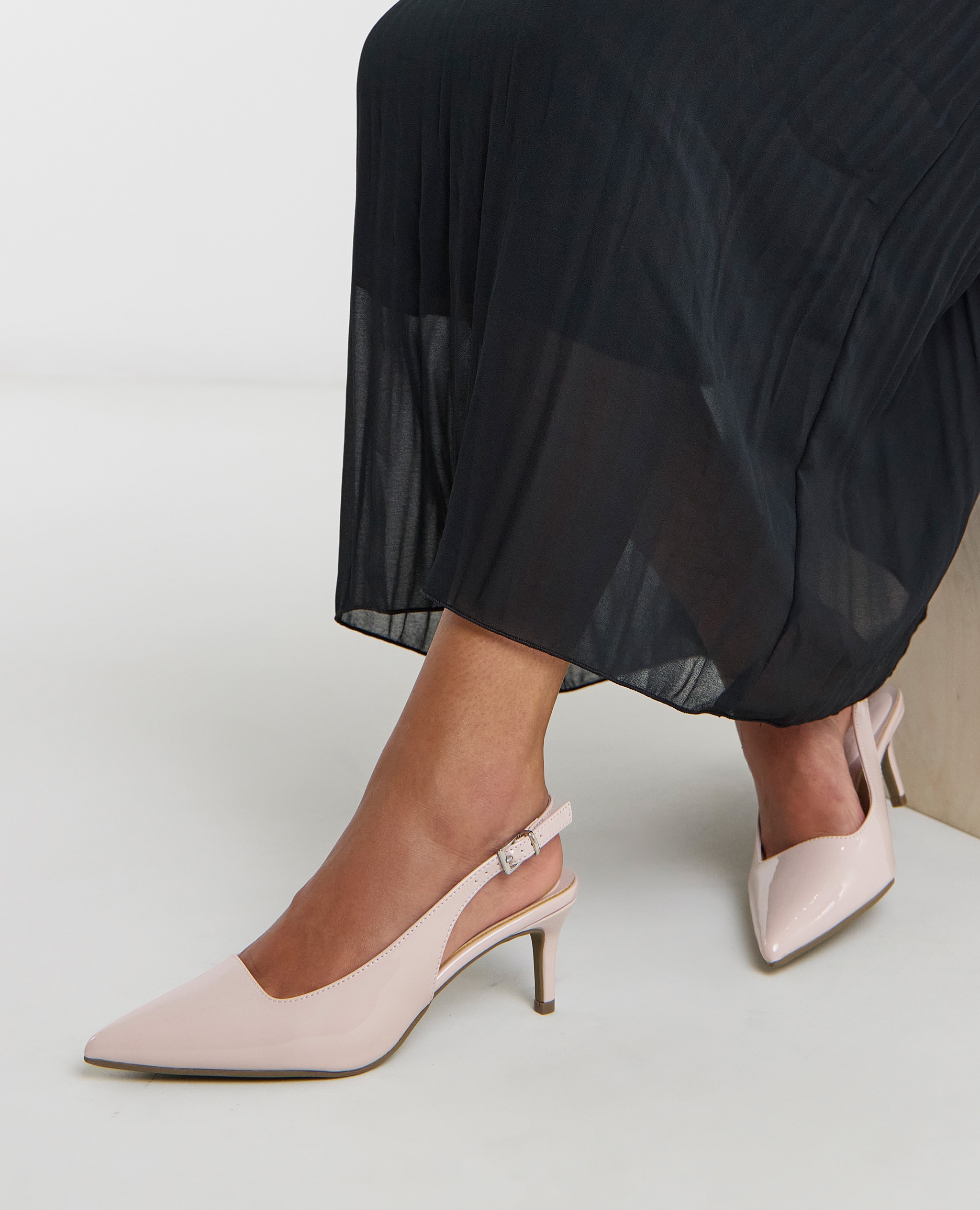 Model wearing pink sling back heels