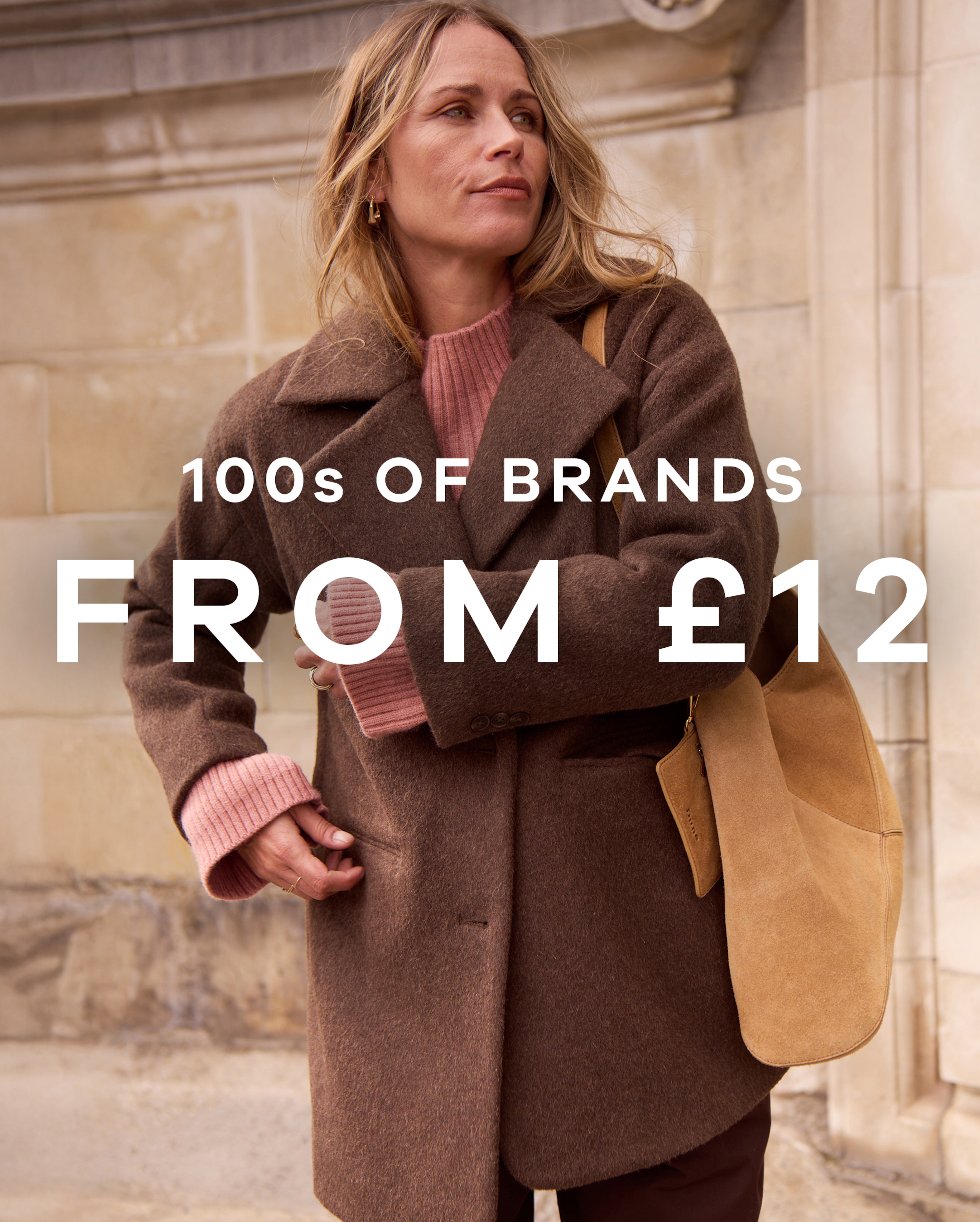 100s of brands from £12 text overlaid on an image of a person wearing a brown coat.