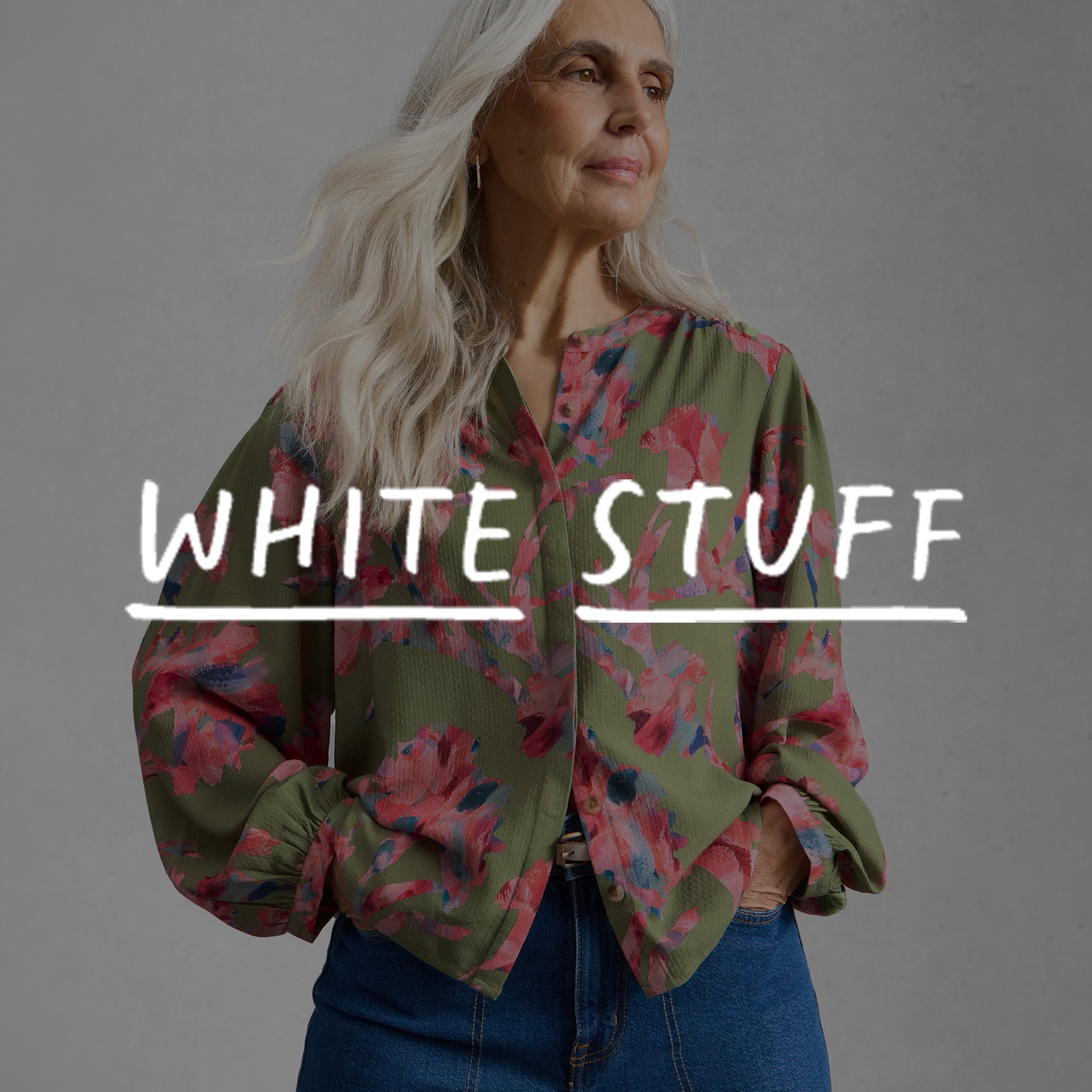 A lady wearing a green White Stuff blouse. The White Stuff logo overlaid on the image.