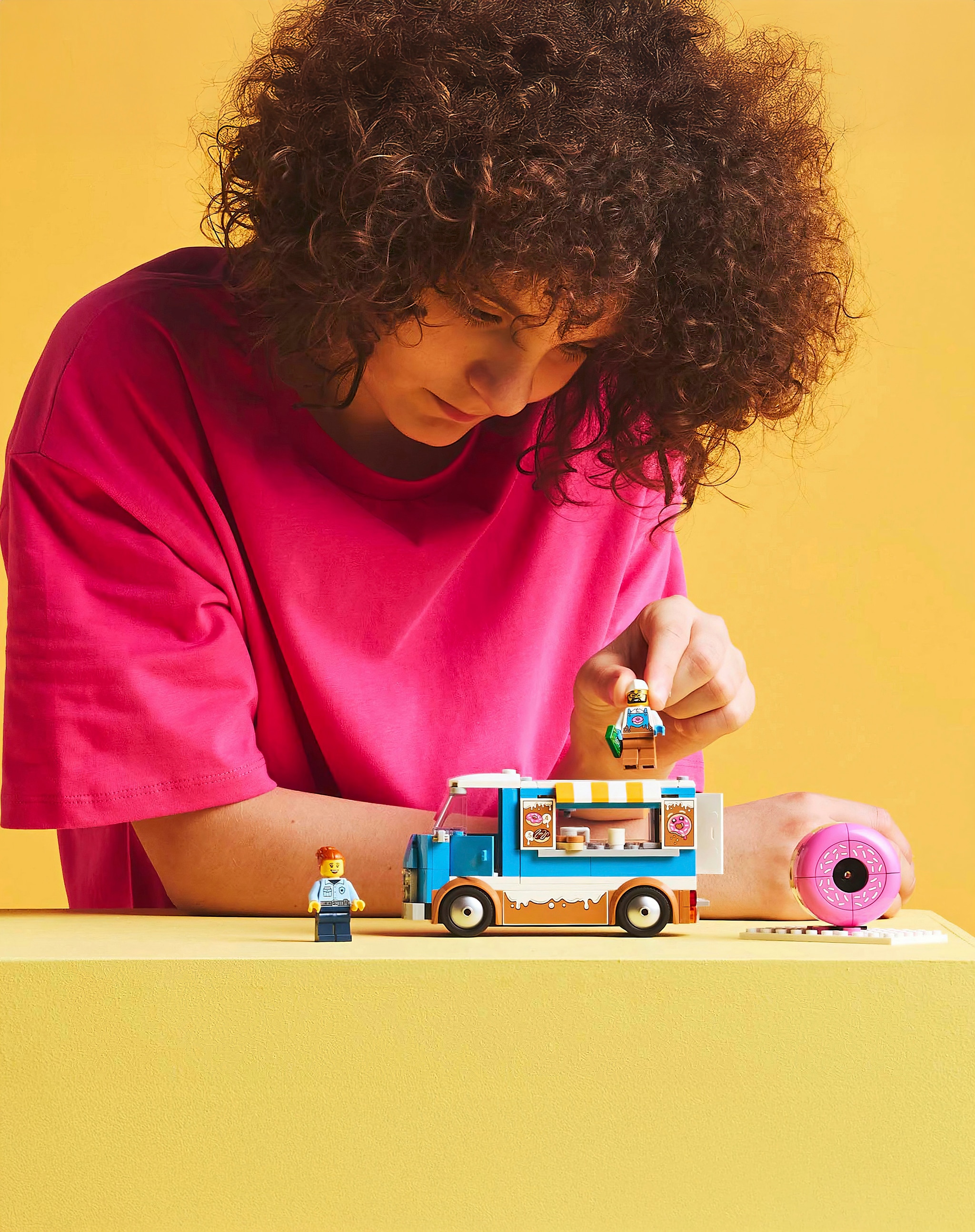 A person playing with a LEGO® City playset