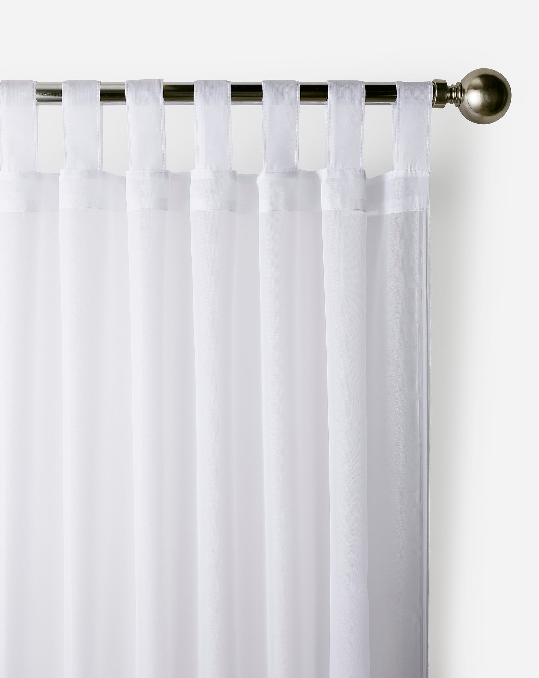 Top detail of white tabbed curtains