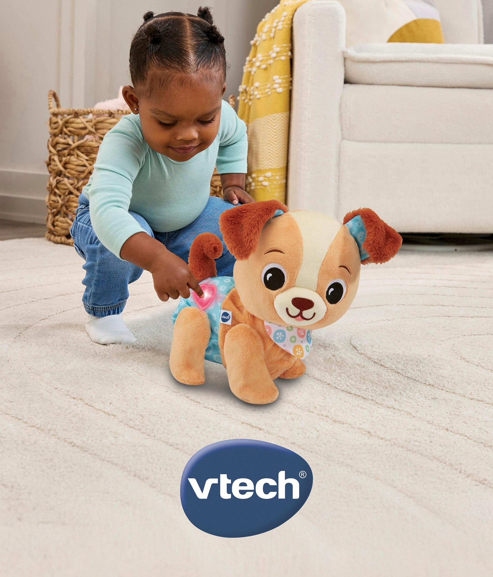 Child playing with a vtech soft toy.
