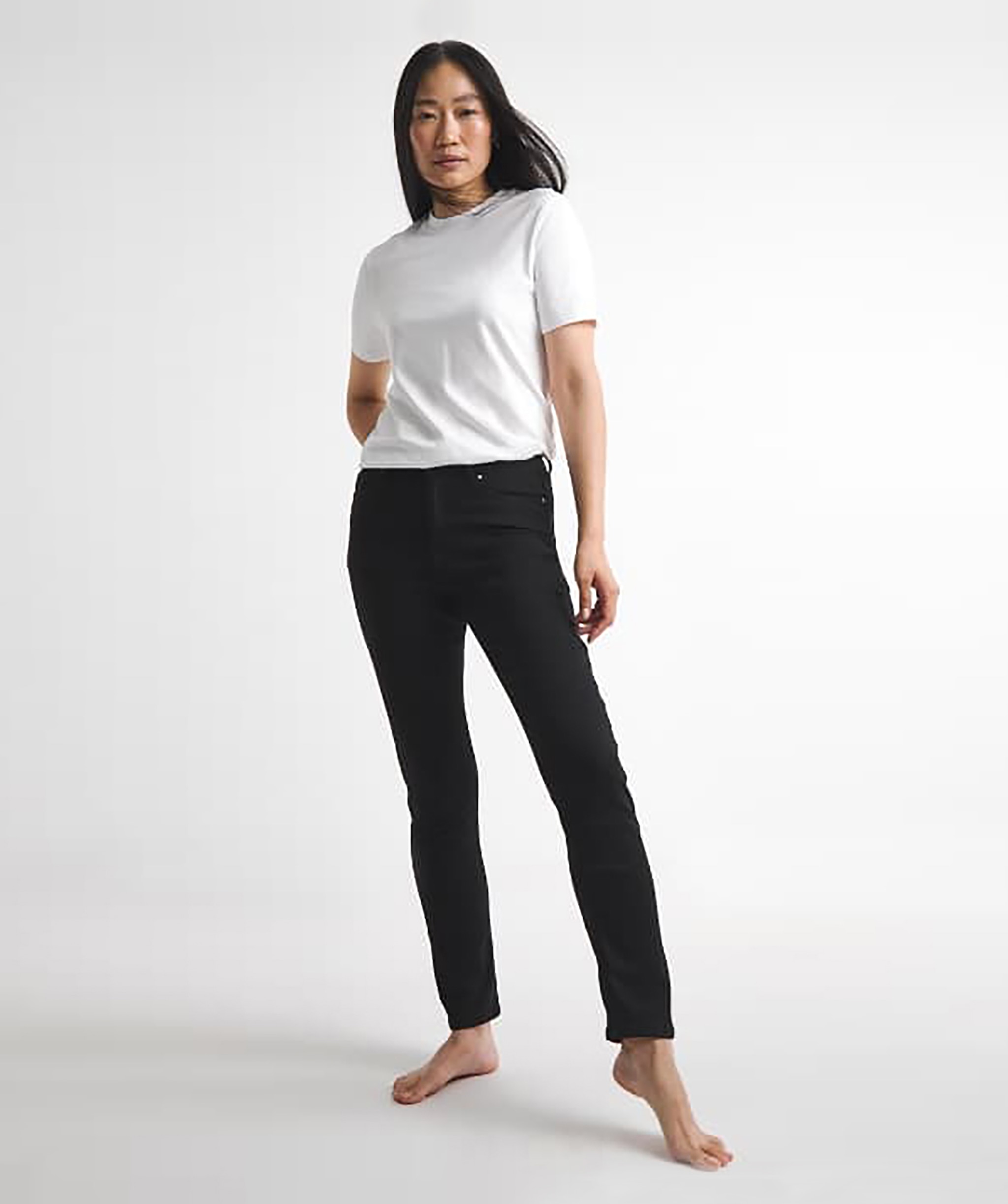 Woman wearing slim fit black jeans and a white t-shirt
