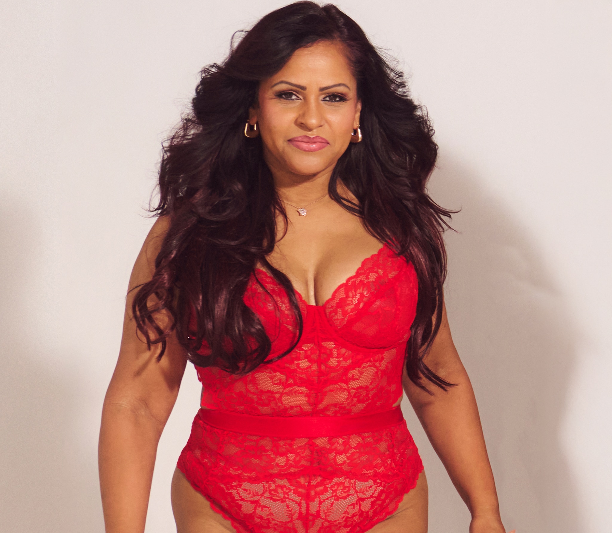 A head and shoulders image of a lady wearing red lingerie