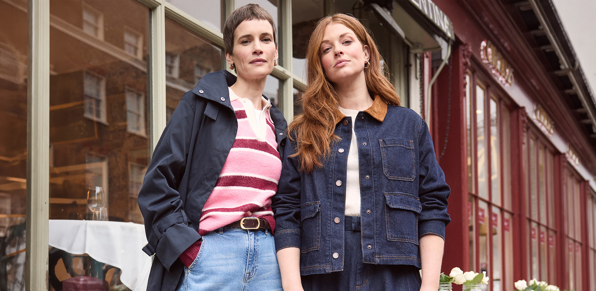 Two ladies stood outside a shop front.