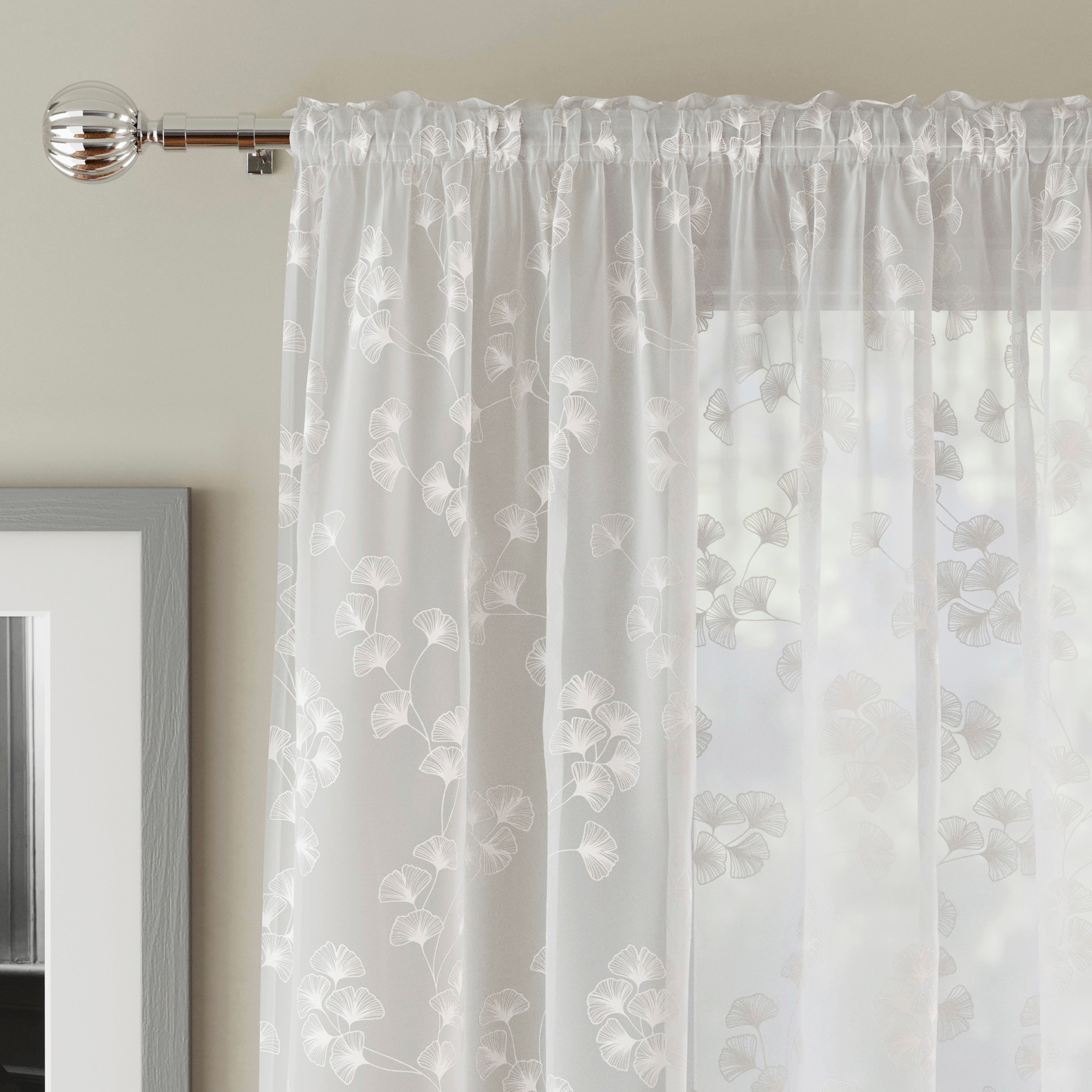 Top detail of white lacy curtains