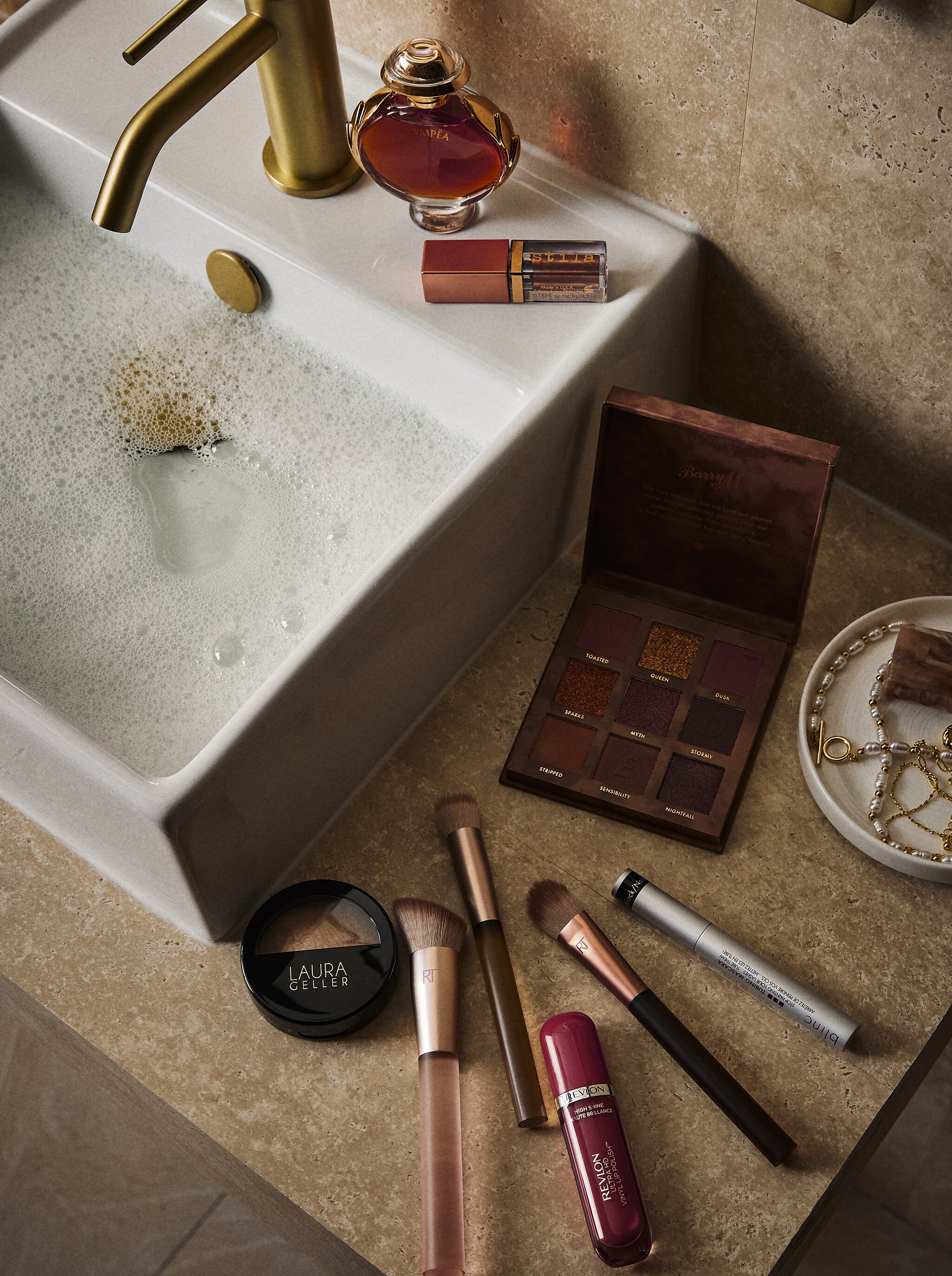 Bathroom sink with make up on worktop