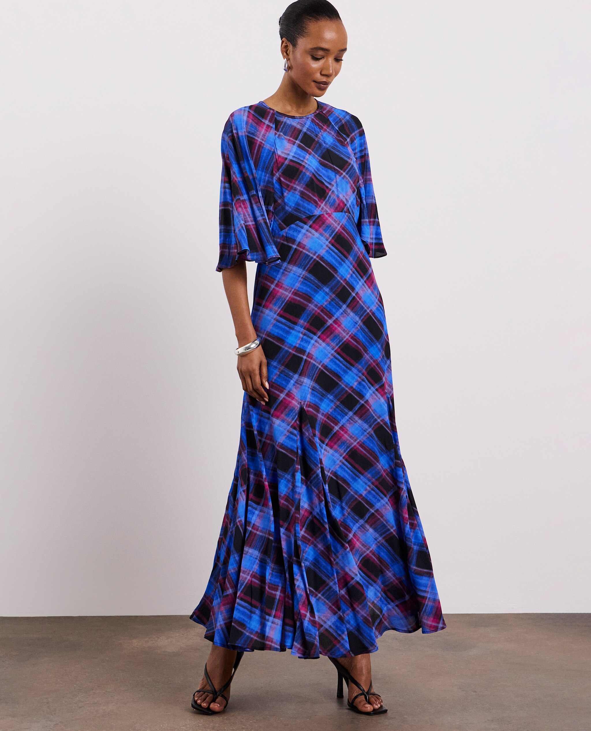 Model is wearing a Joanna Hope check print tea dress.