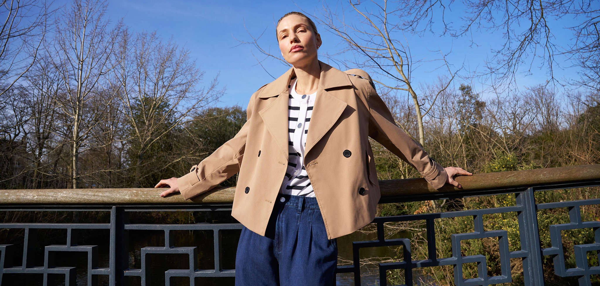 Lady wearing brown coat and blue jeans