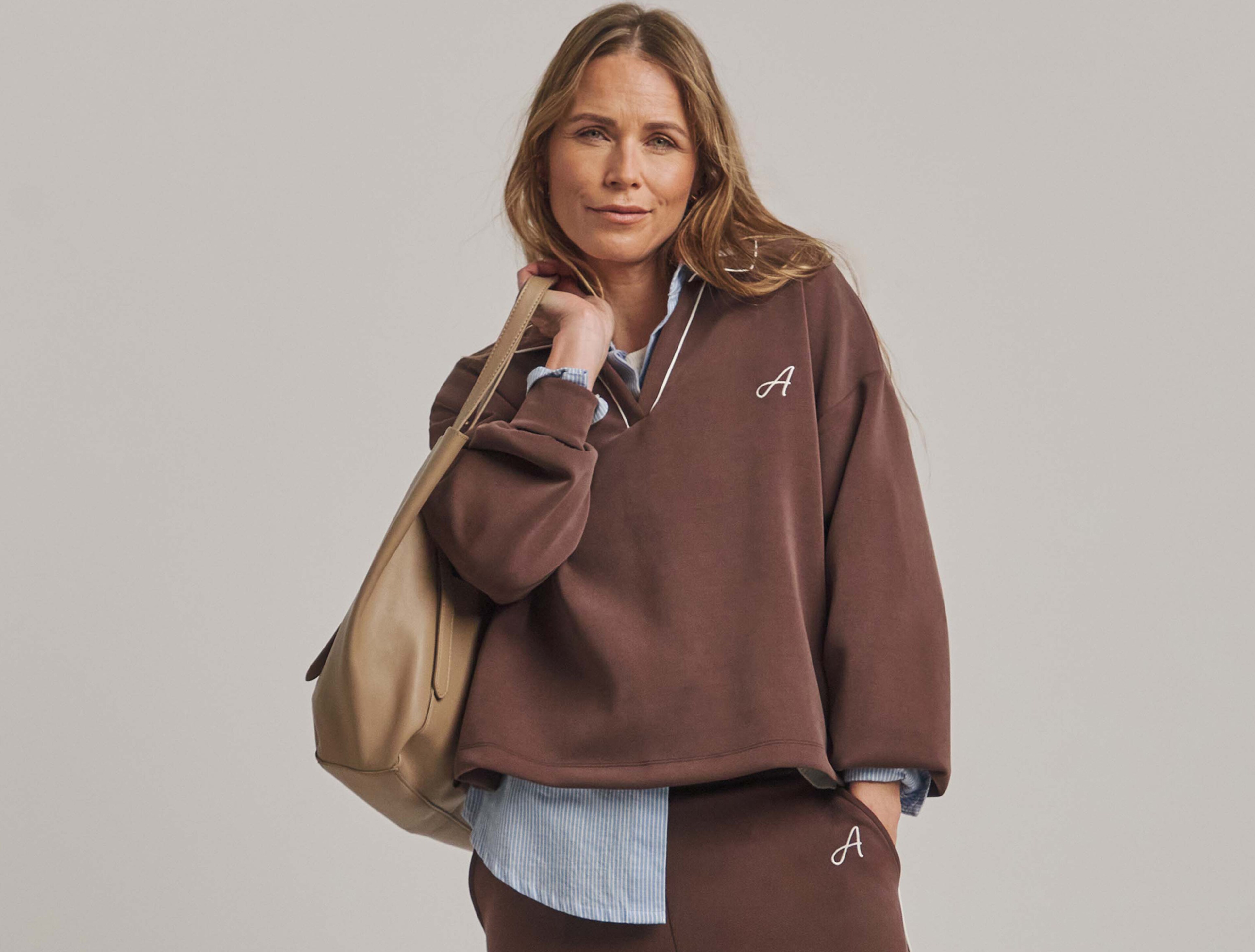 A lady weating an Anthology collared sweatshirt