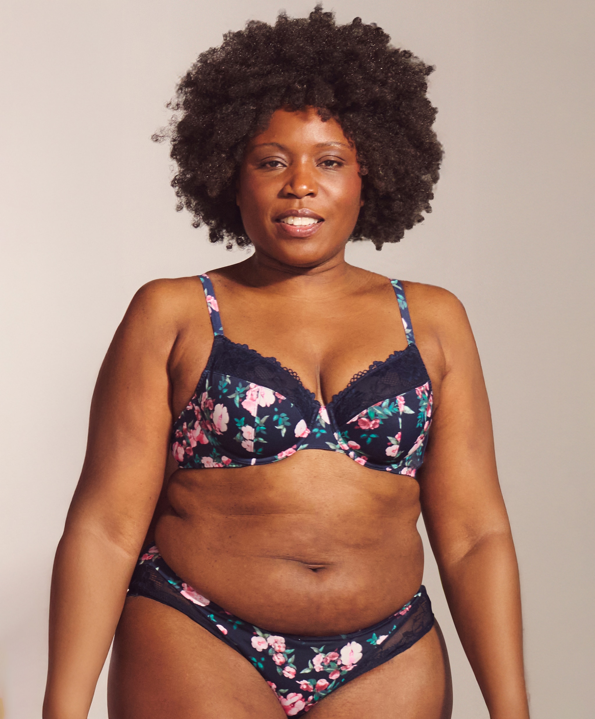 A head and shoulders image of a lady wearing blue floral patterned lingerie