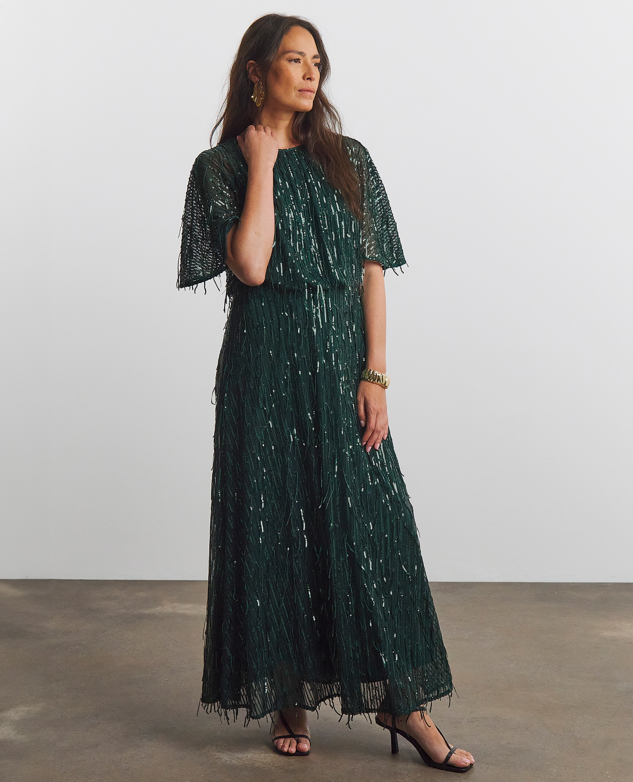 Model wearing a sequin green maxi dress