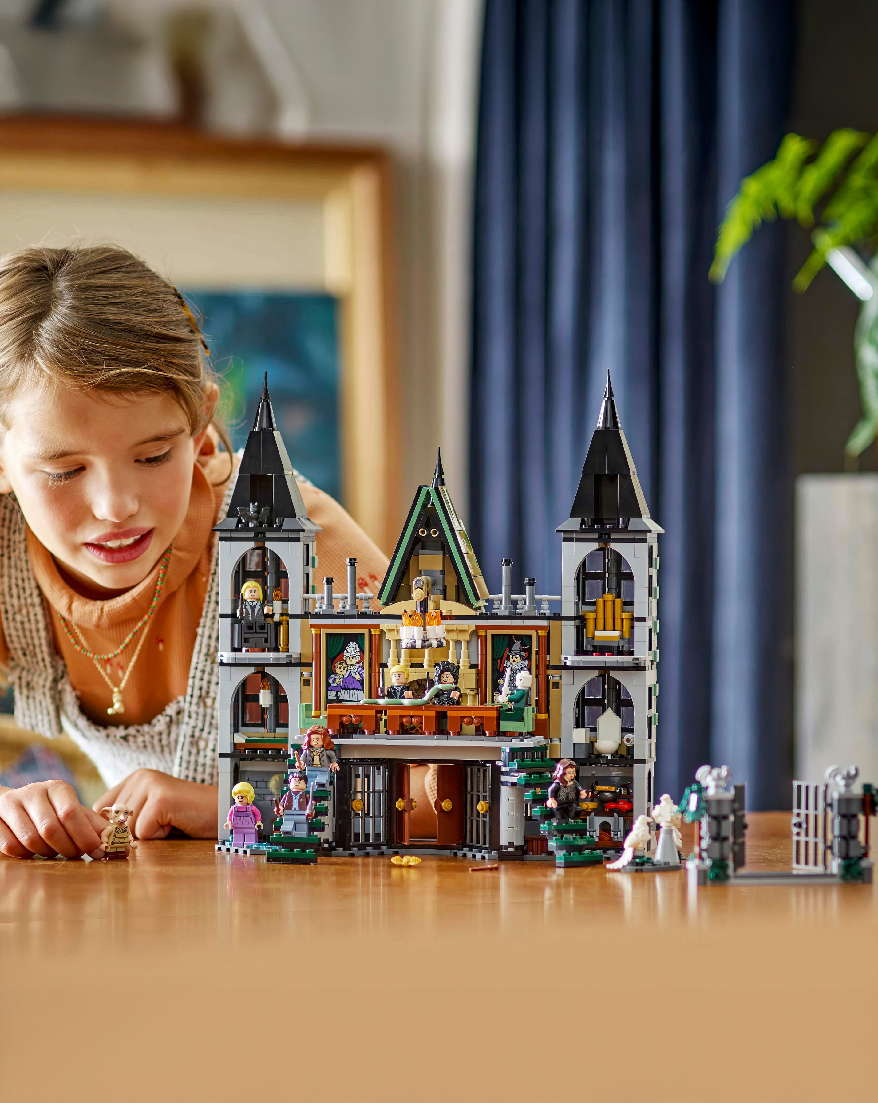 A child playing with a LEGO® Harry Potter™ playset