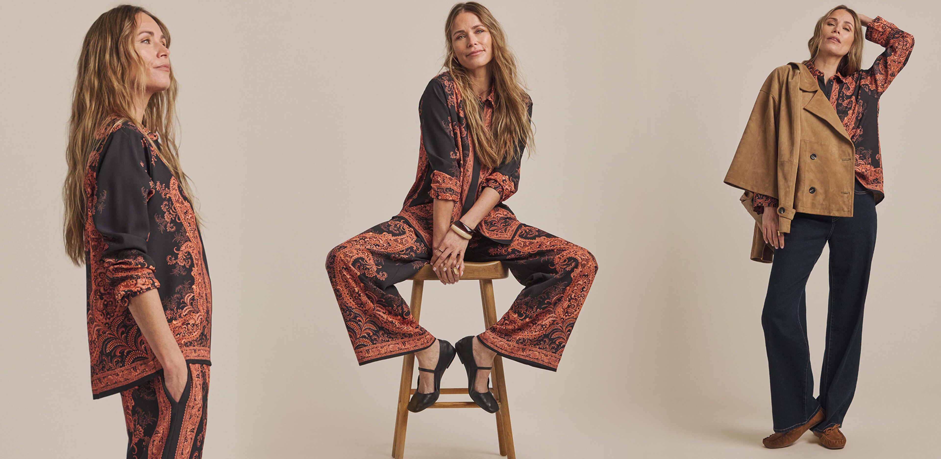 A lady sat on a stool wearing an Anthology Print Shirt and trouser suit.