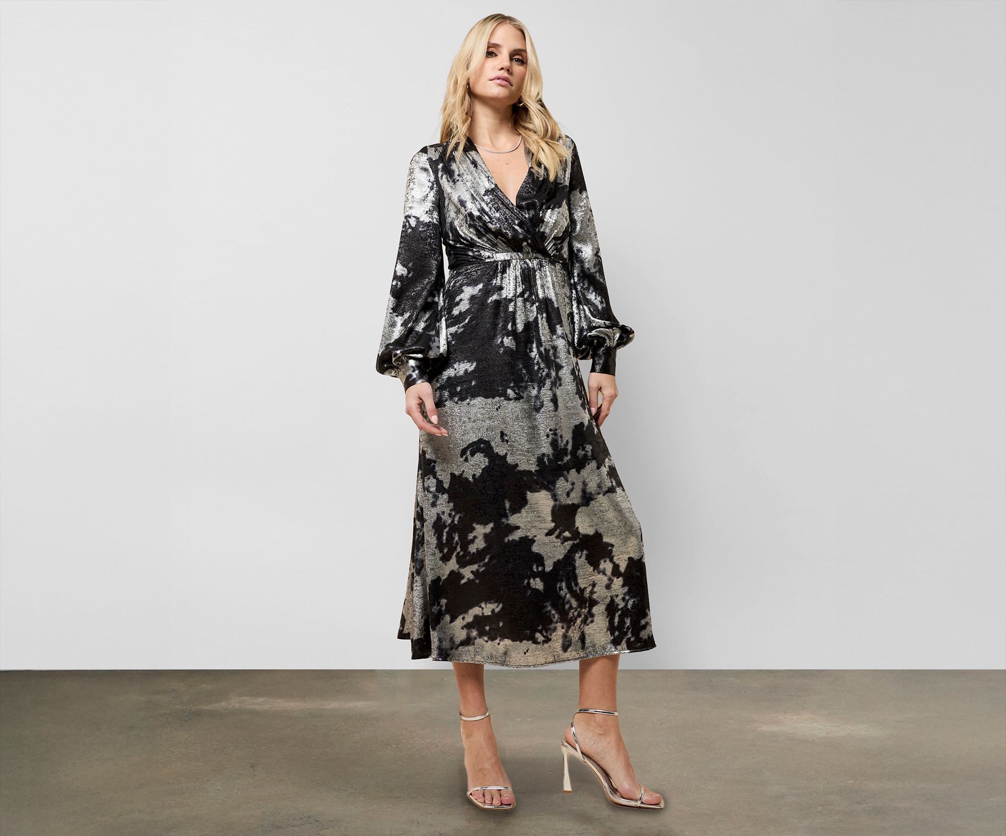 A lady wearing a shiny silver and black dress