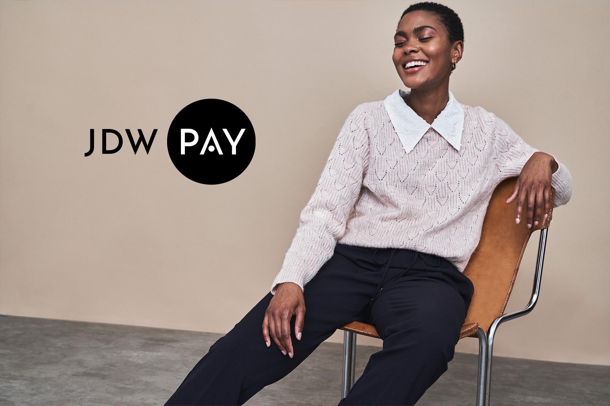 JDW Pay Logo and model sitting and smiling in the background