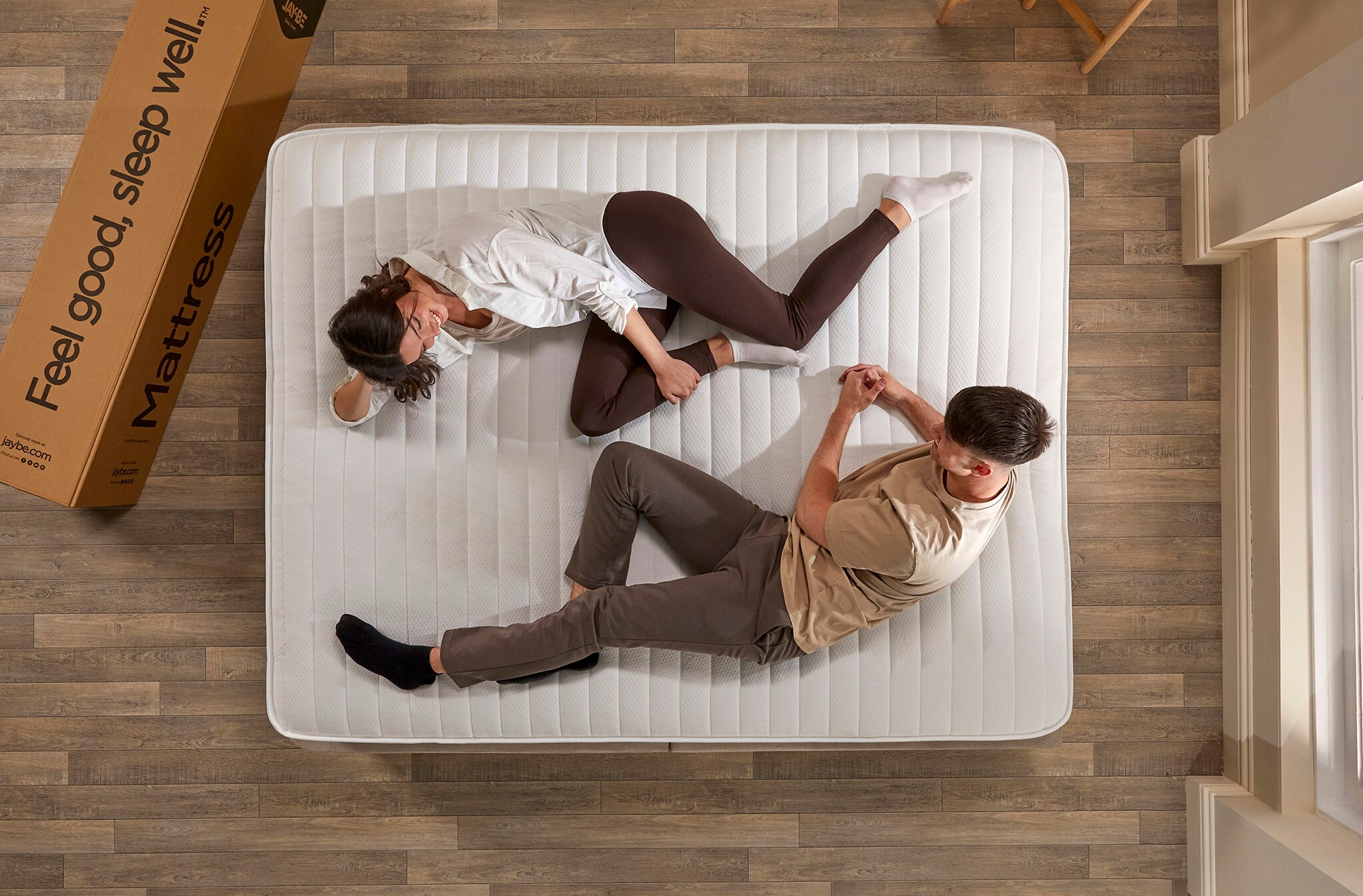 Two people lying on a mattress