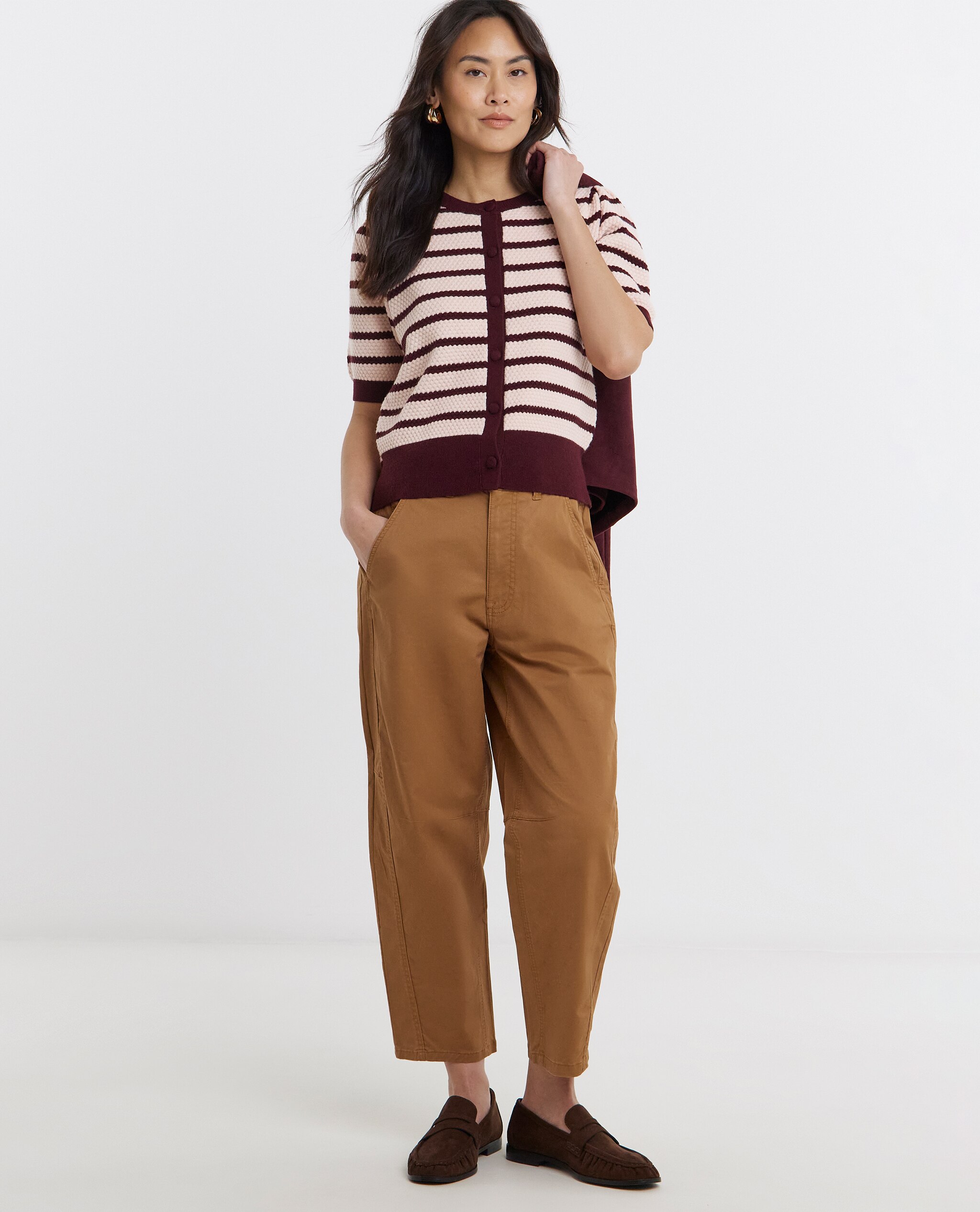 Model is wearing a textured stripe short sleeve cardigan with capri trousers.
