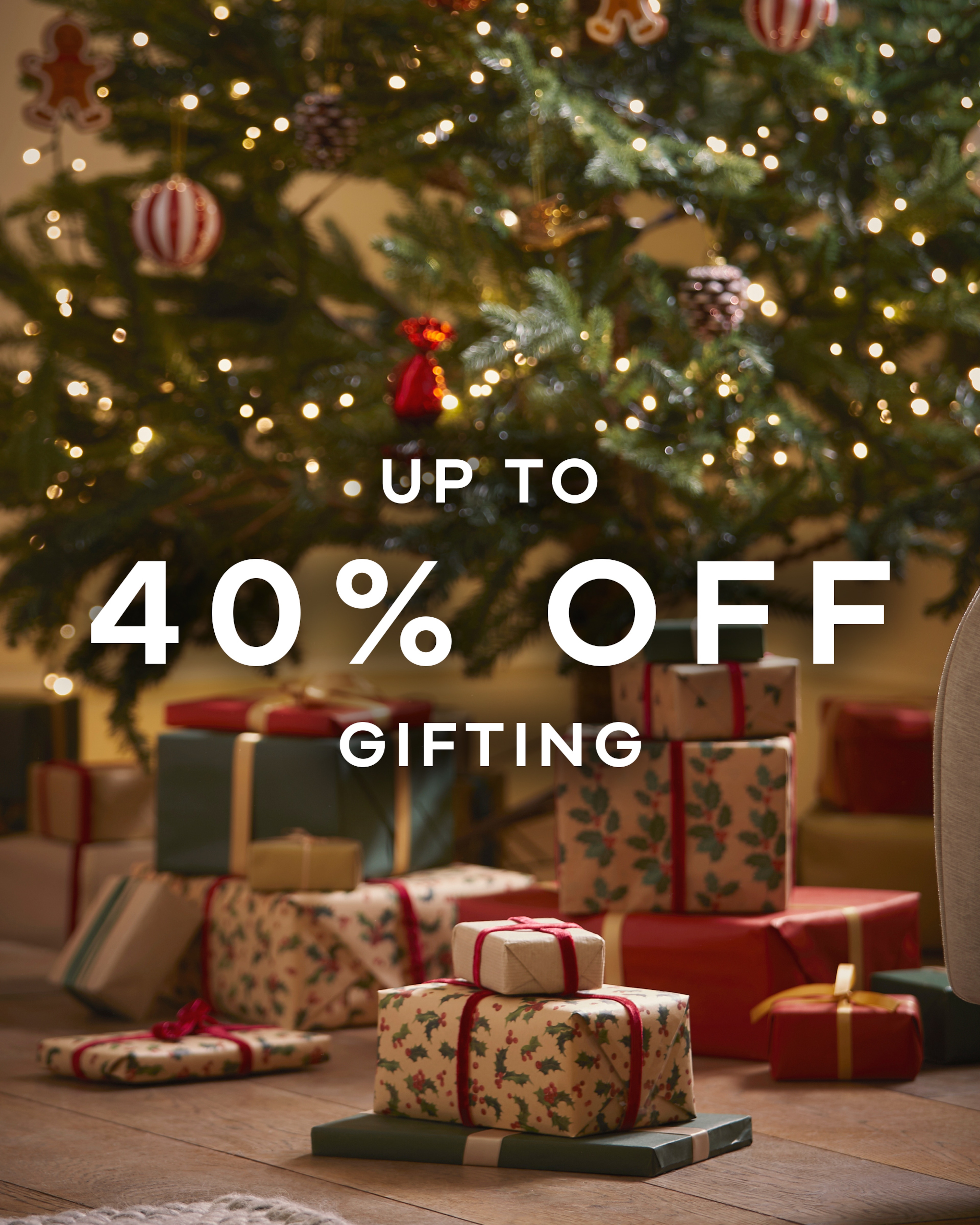 Up to 40% off gifting text overlaid on a Christmas tree image