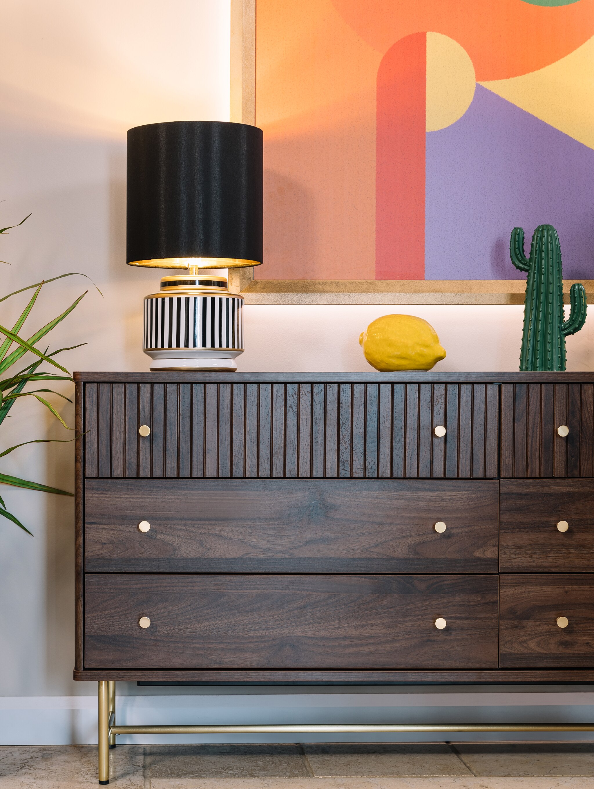 Dark wood sideboard with lamp on top