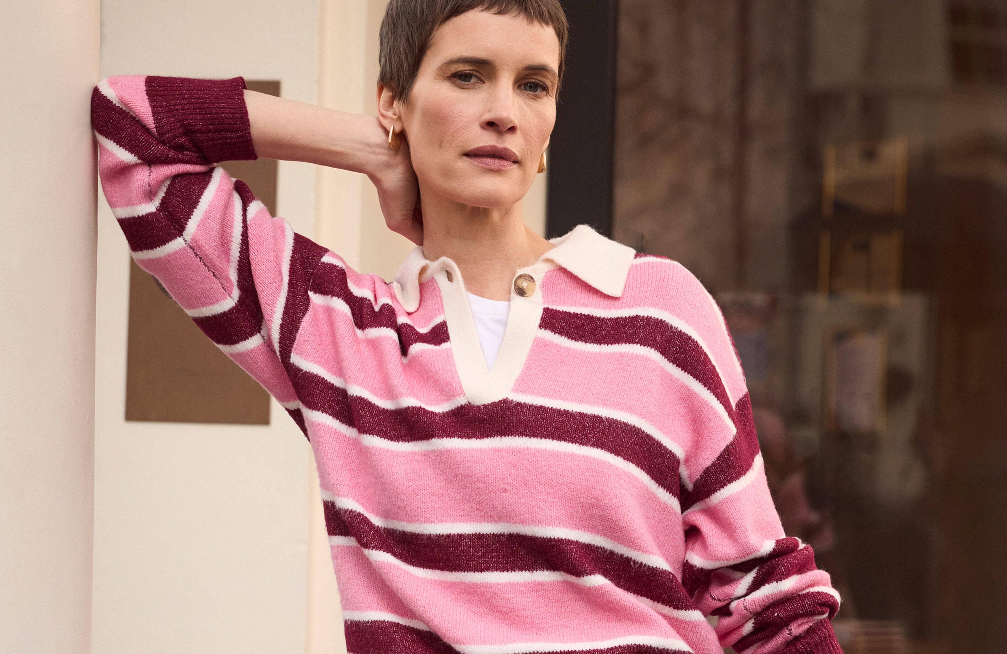 Model is wearing a stripe knitted rugby jumper