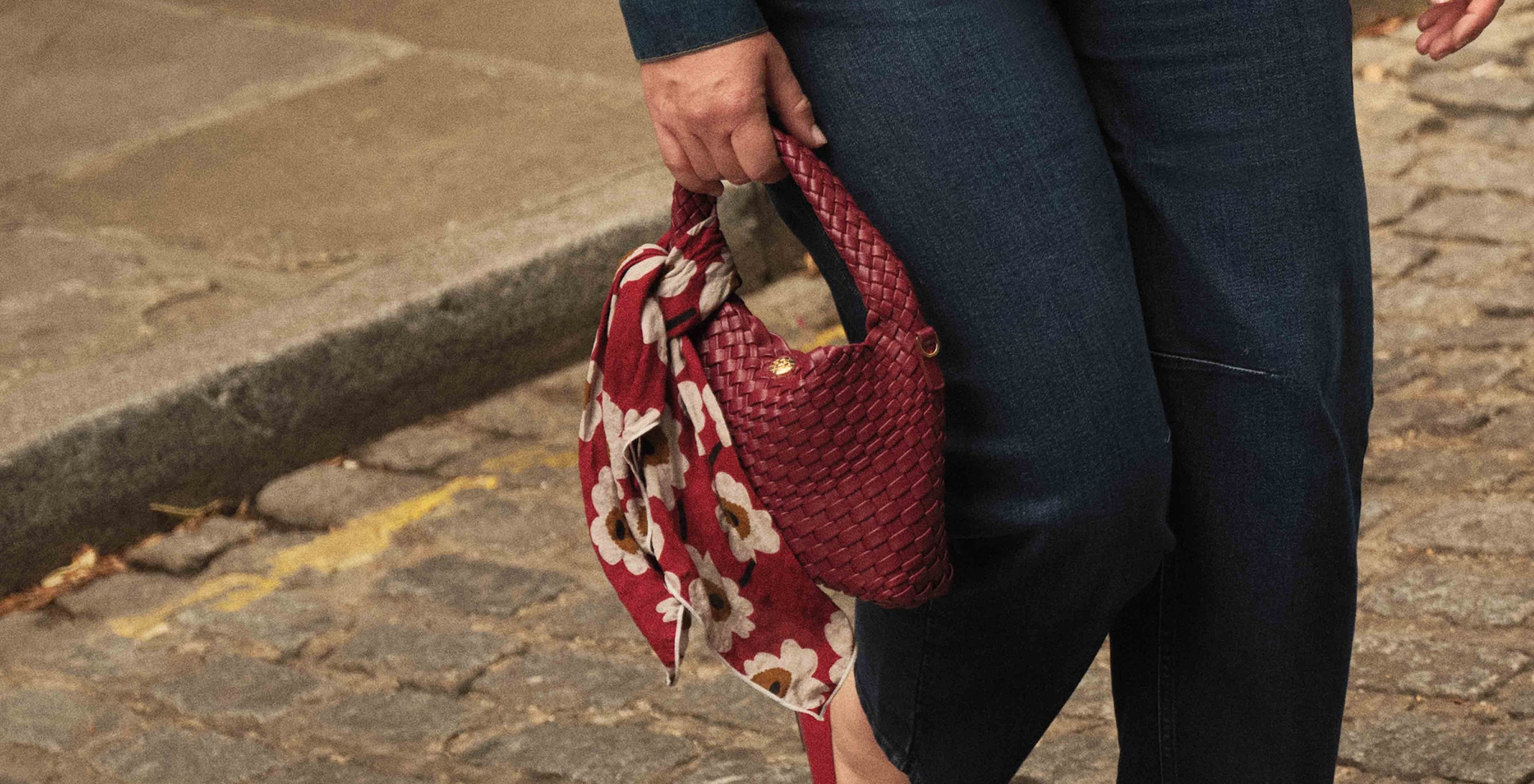 A person holding a red bag