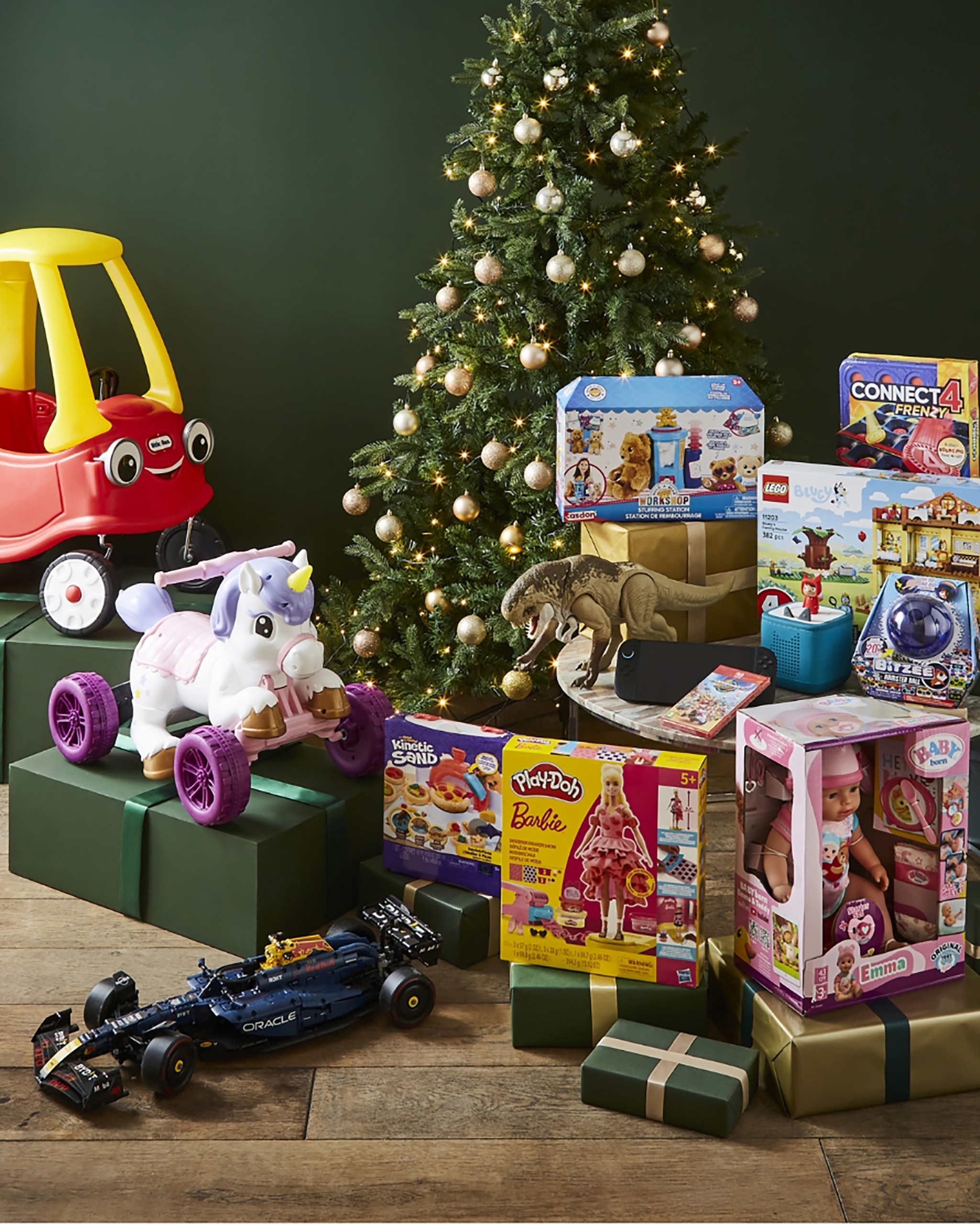 Festive Toys and Gifts Under a Christmas Tree With Dolls, Cars, and Play Sets
