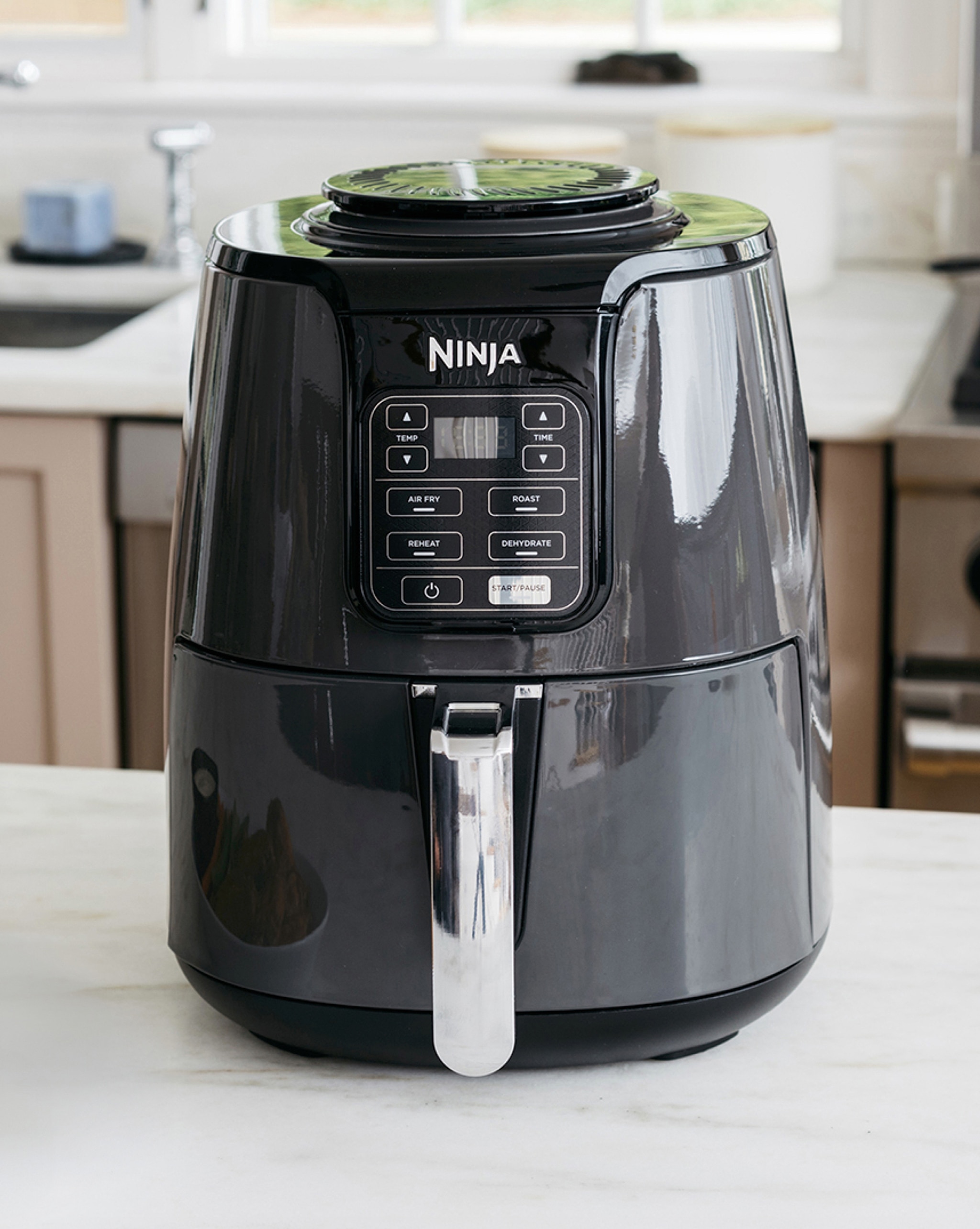A Ninja cooking appliance on a kitchen worktop.