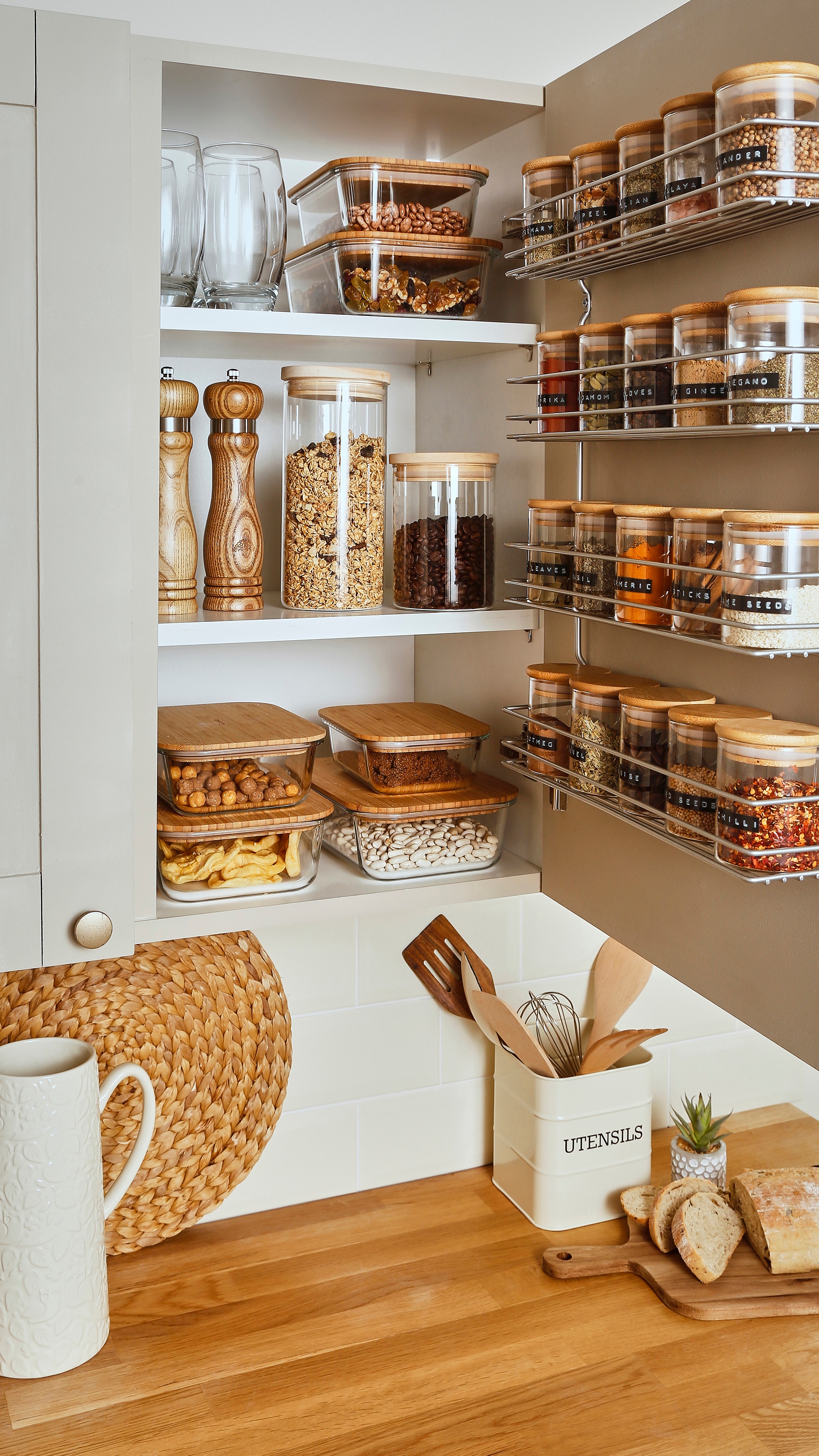 Lots of kitchen glass storage containers with wooden lids.