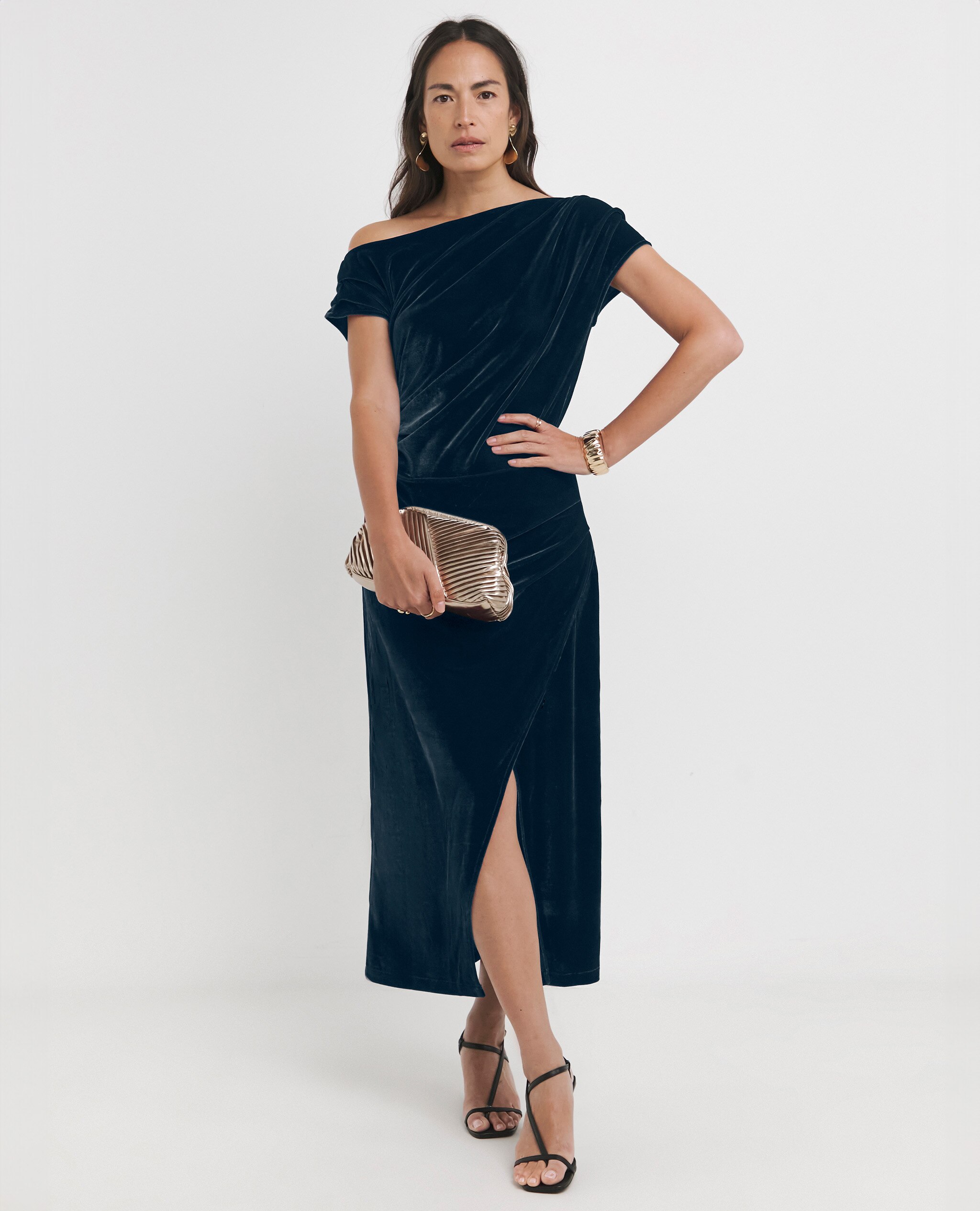 Model wearing an off the shoulder velvet dress