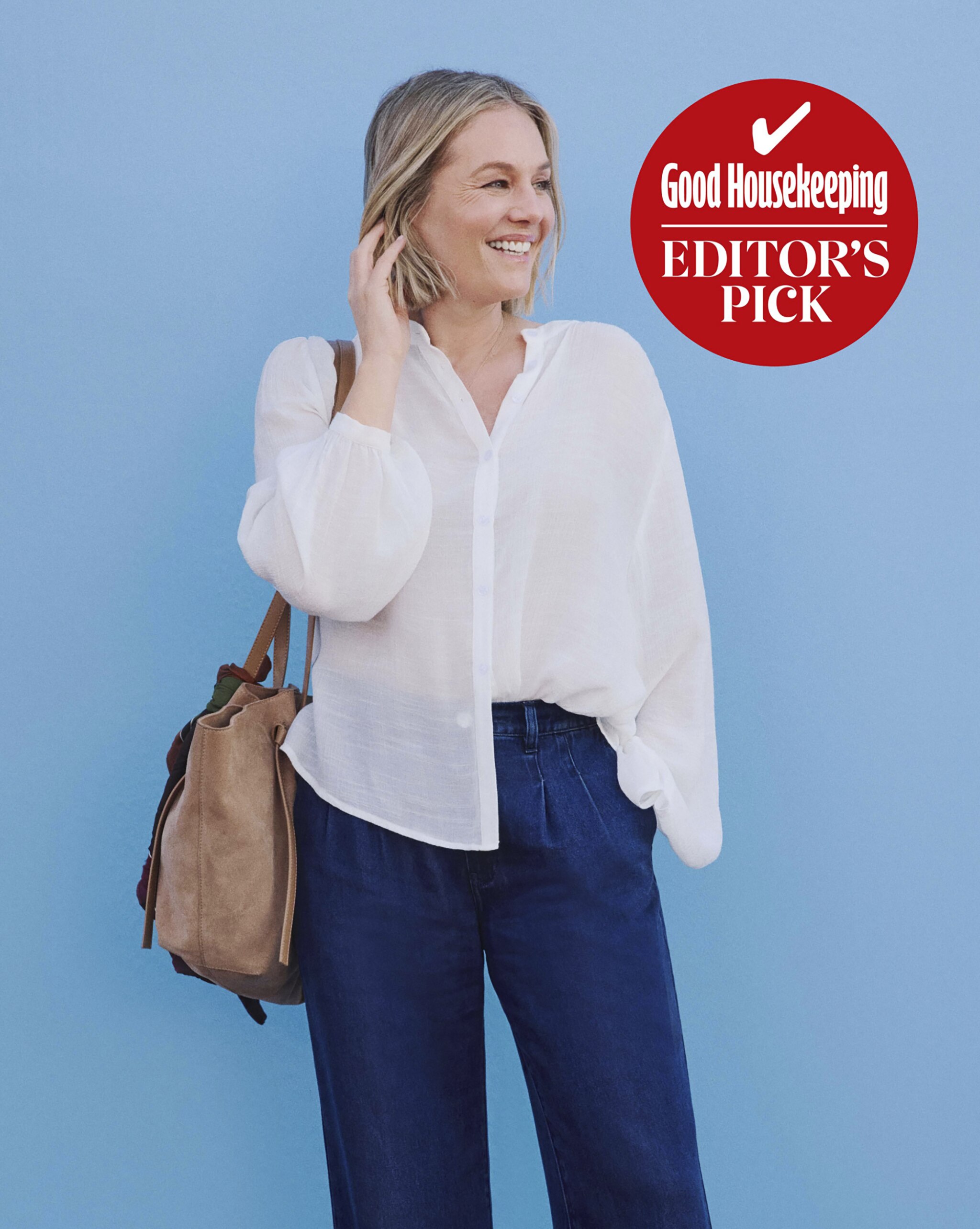 A lady wearing a white blouse with dark blue jeans