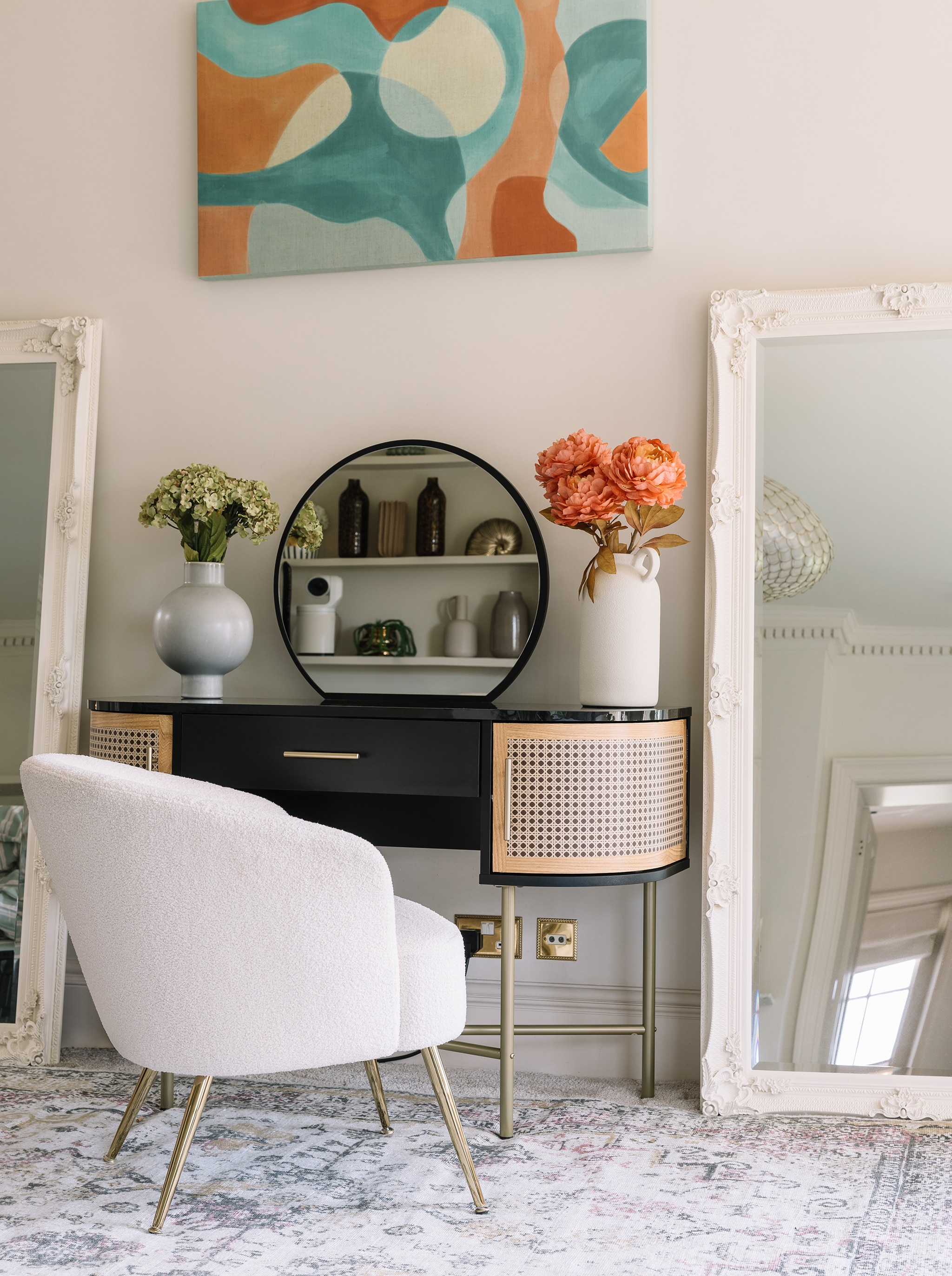 A white chair in front of a dressing table