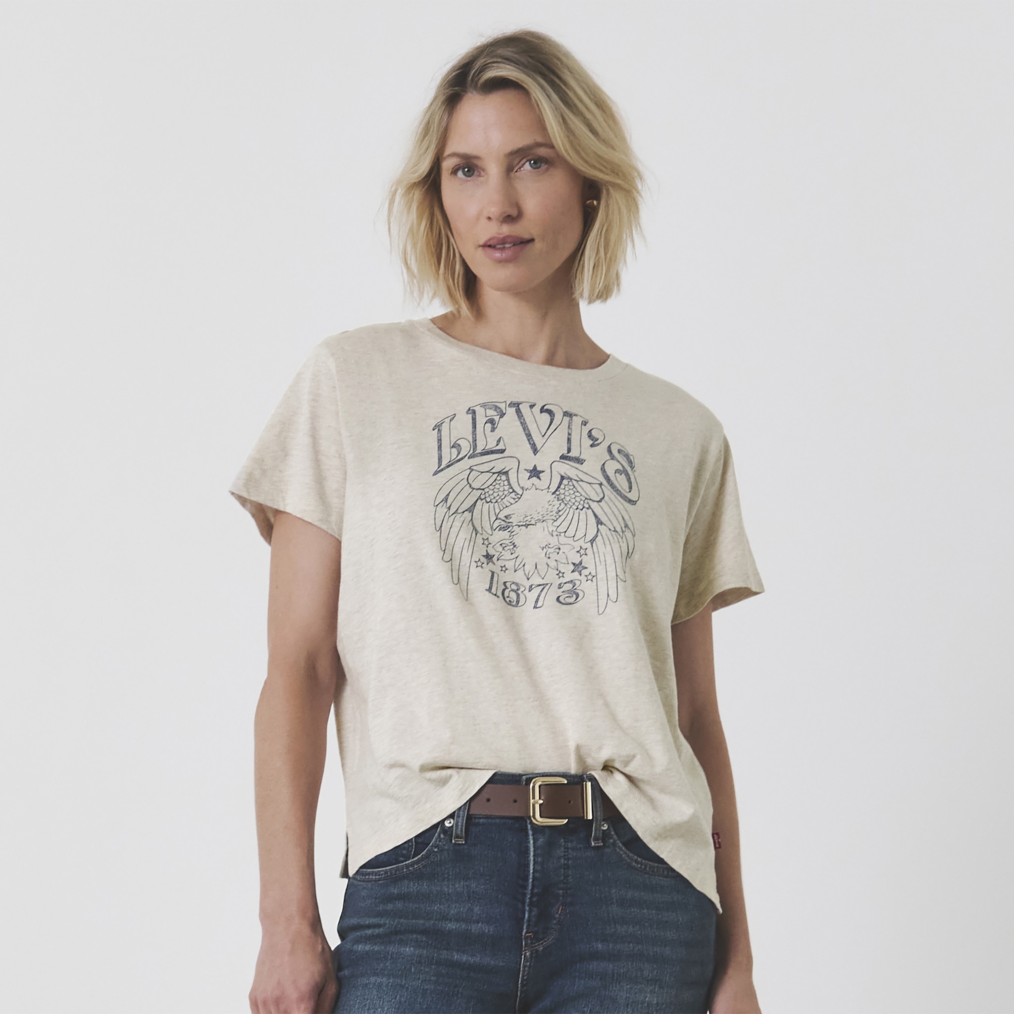 Lady wearing a stone coloured Levi's printed t-shirt