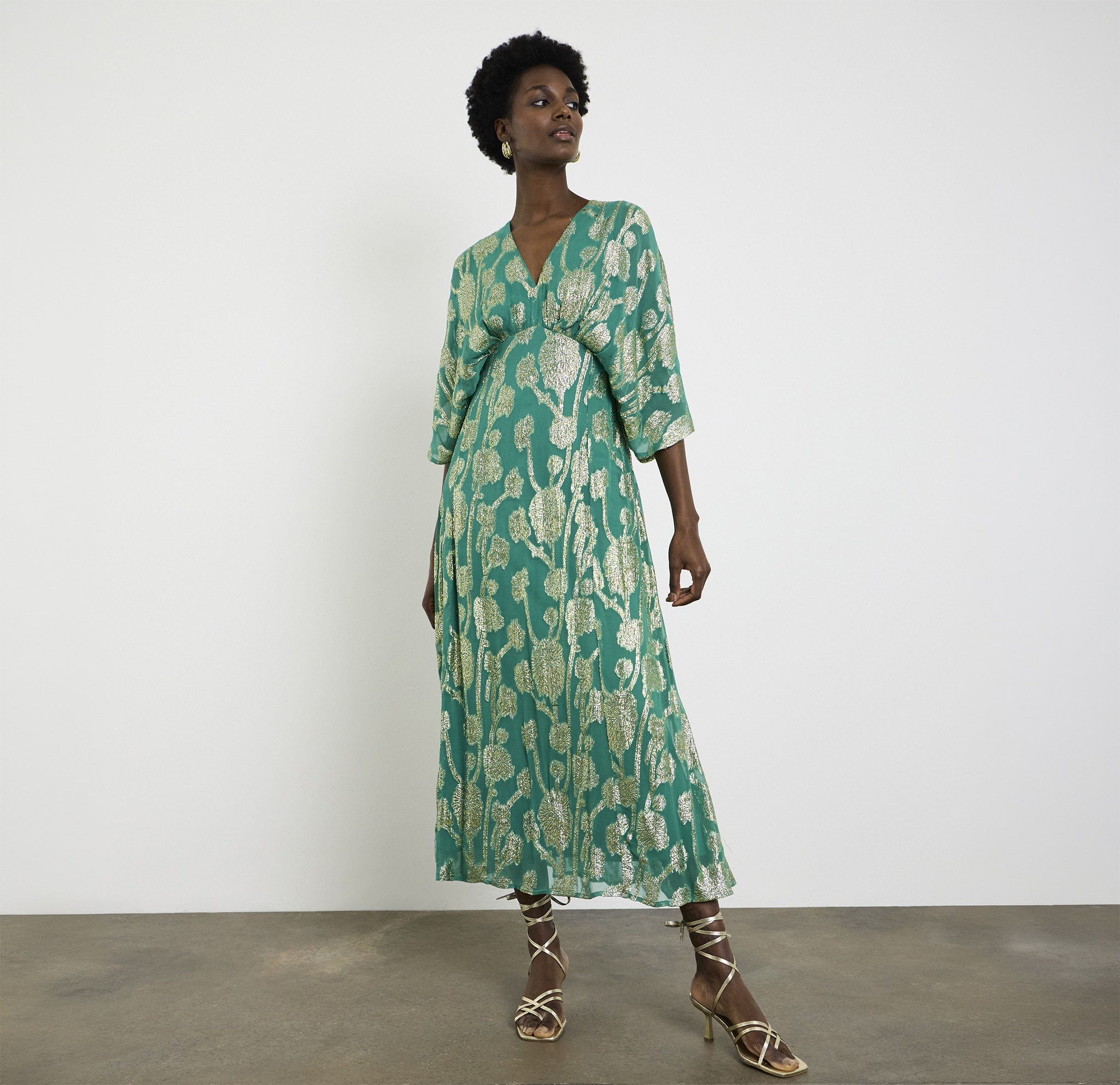 A lady wearing a Joanna Hope metallic jacquard tea dress