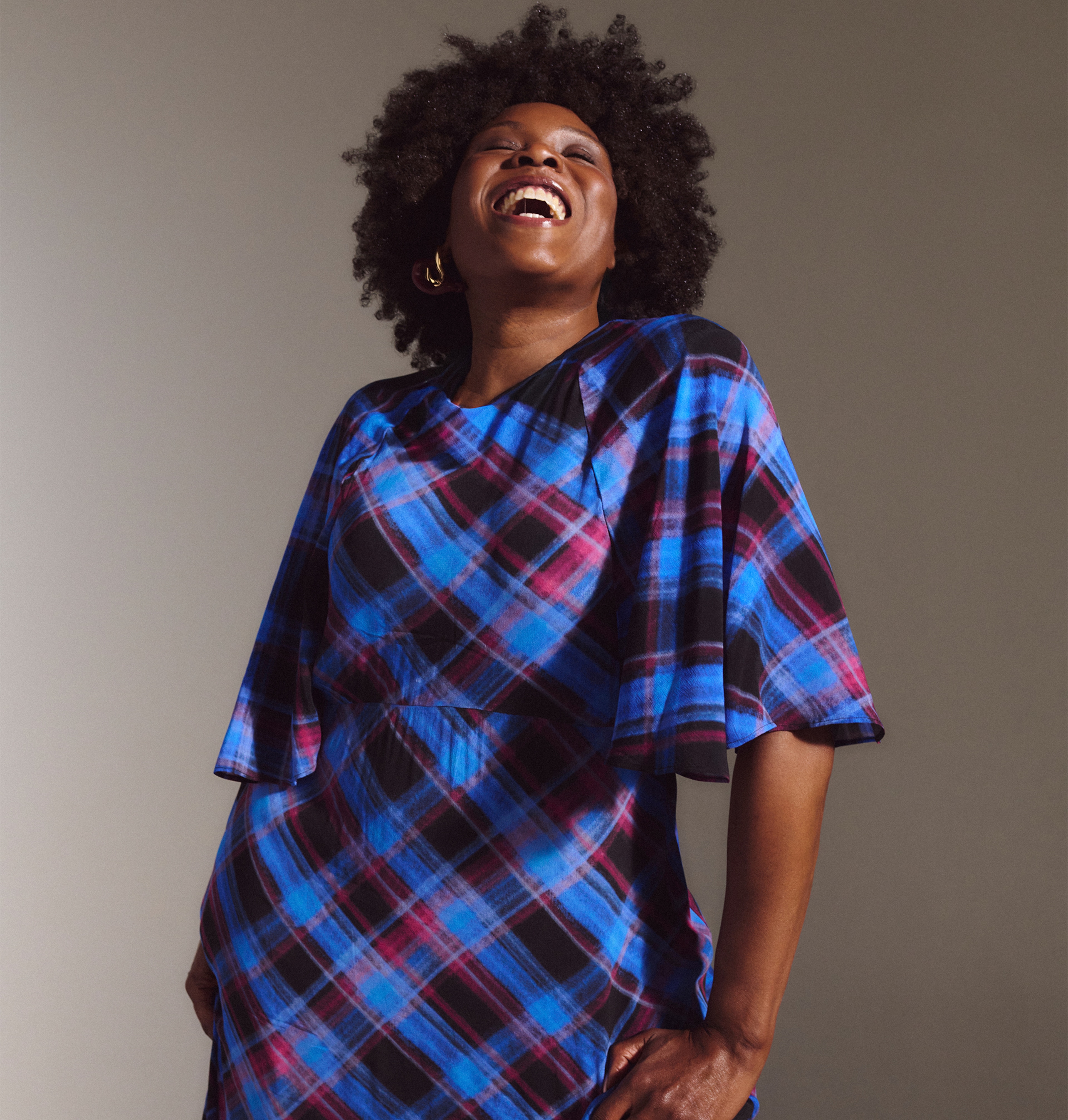 A lady wearing a check print tea dress