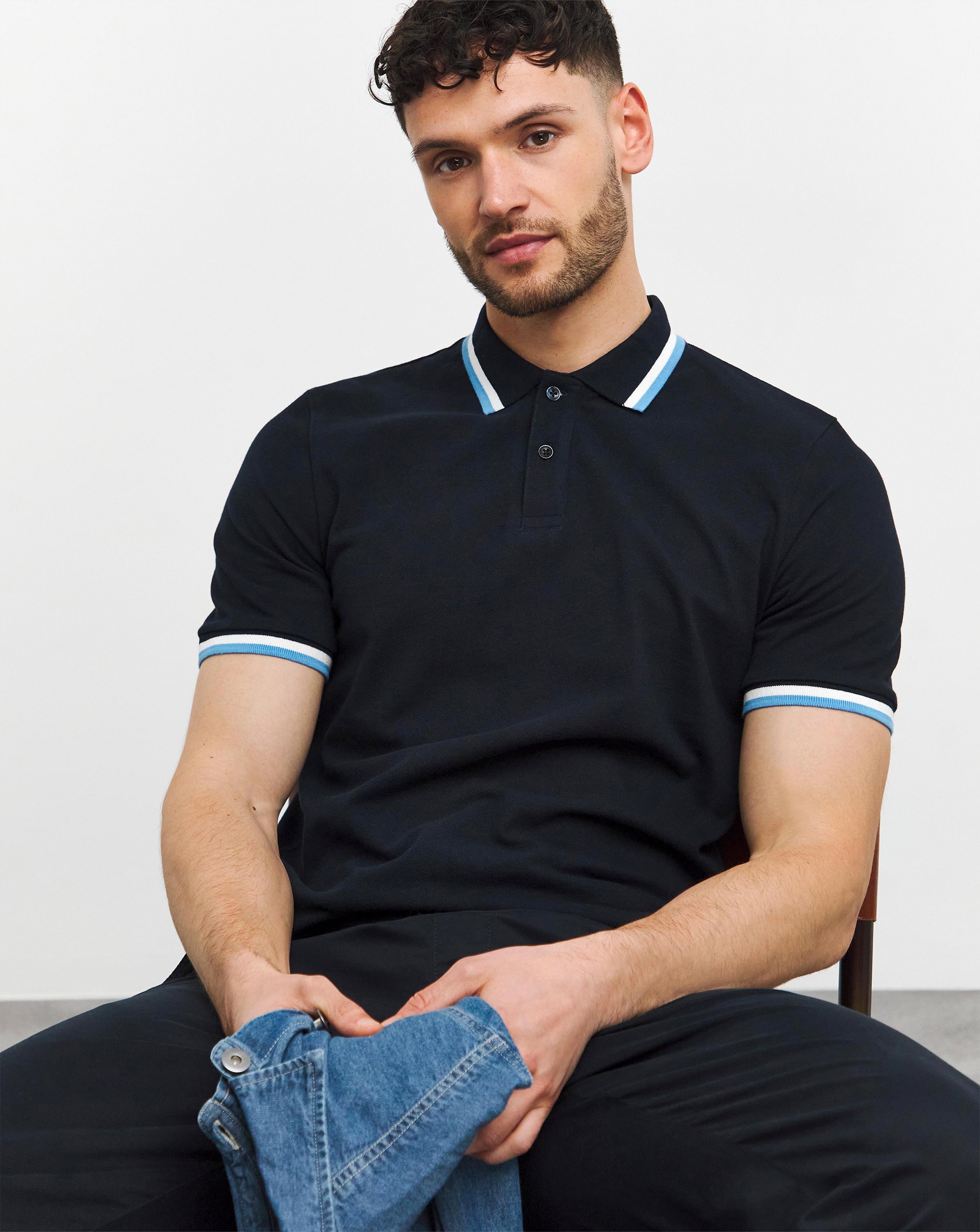 Model wearing a navy-coloured polo shirt