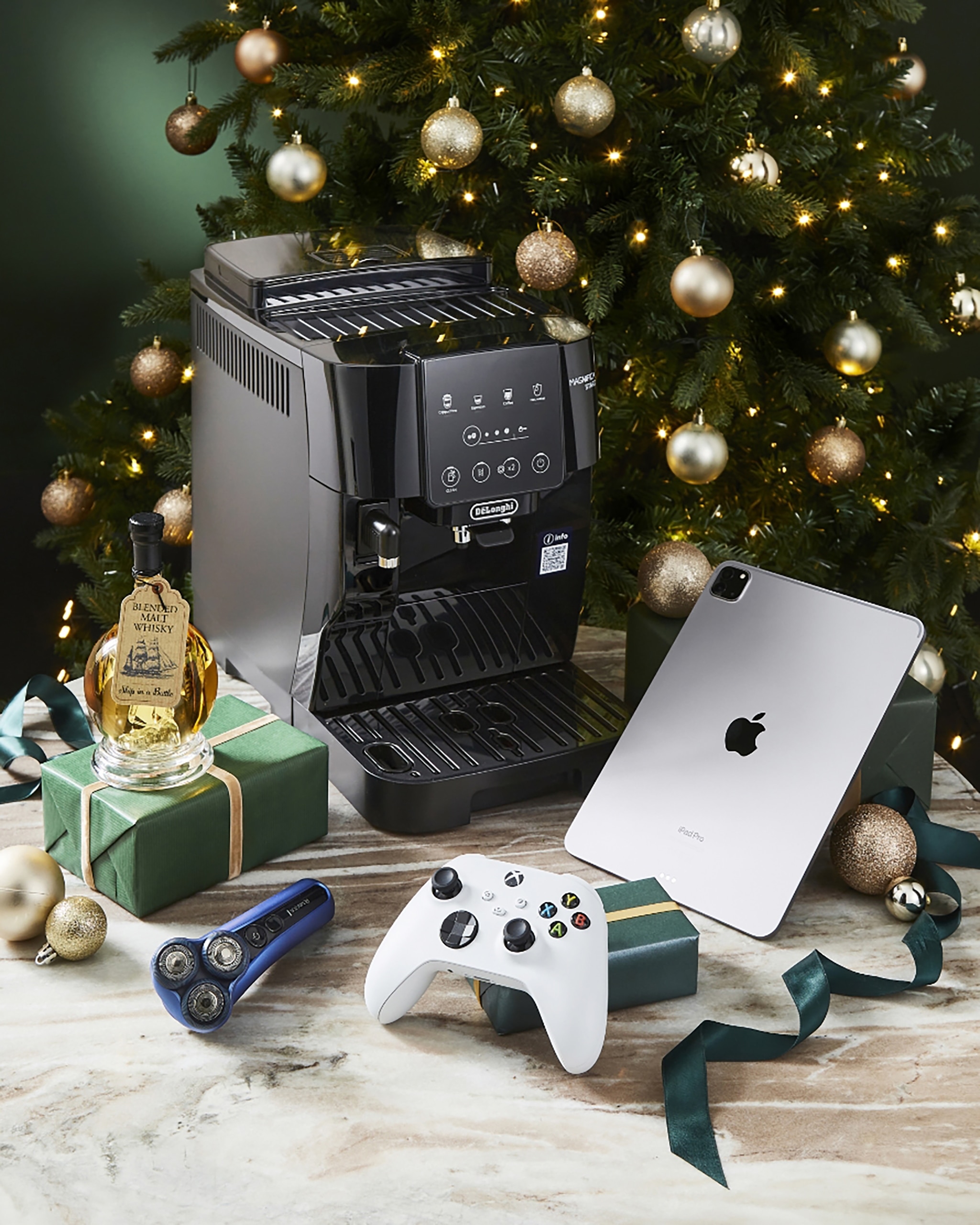 Festive Home Office Scene With Espresso Machine, Gifts, Tablet, Controller And Christmas Tree